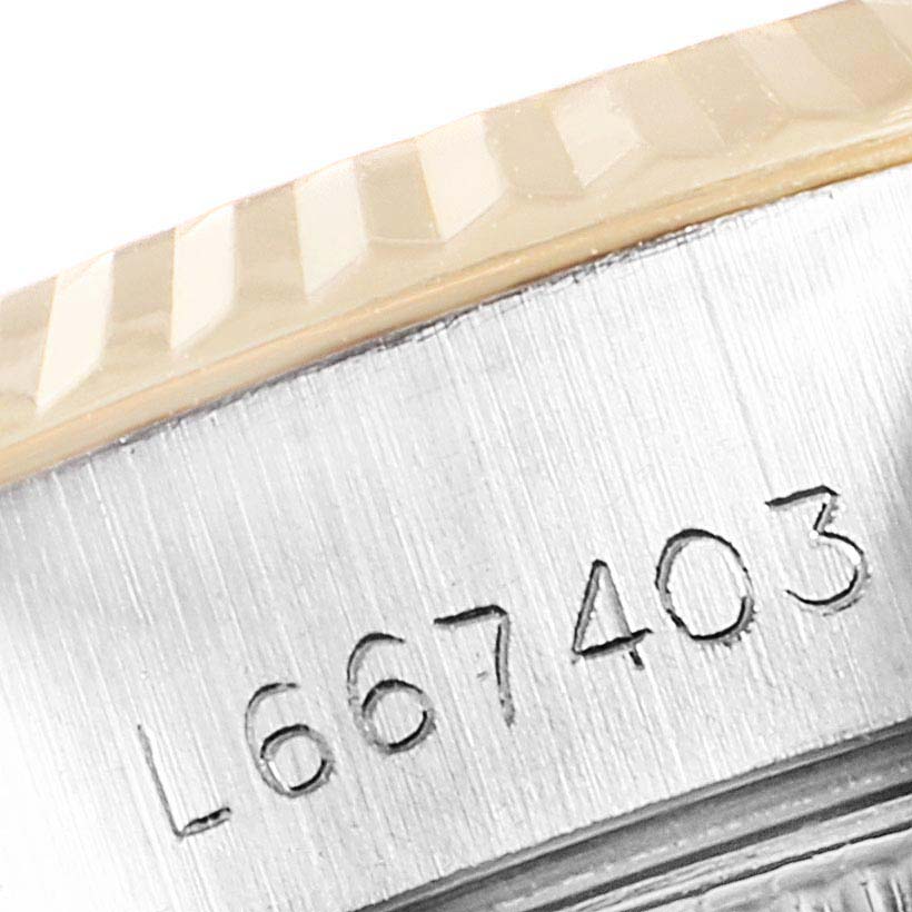 The image shows a close-up of the serial number and fluted bezel of the Rolex Datejust 69173 Women
s Steel and Gold (two tone) Champagne Dial 69173 Women
s Steel and Gold (two tone) Champagne Dial watch.
