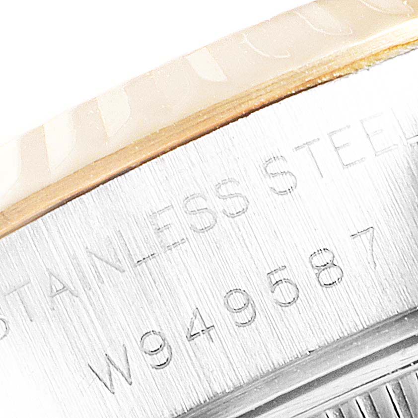 This image shows a close-up angle of the serial number and "STAINLESS STEEL" engraving on the side of a Rolex Datejust 69173 Women's Steel and Gold (two tone) Champagne Dial 69173 Women's Steel and Gold (two tone) Champagne Dial watch's case.