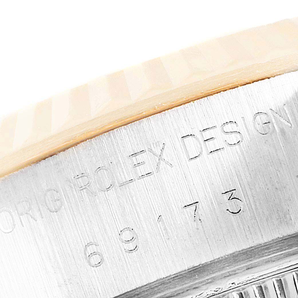 This image shows a close-up of the serial number and part of the bezel on a Rolex Datejust 69173 Women
s Steel and Gold (two tone) Champagne Dial 69173 Women
s Steel and Gold (two tone) Champagne Dial watch.