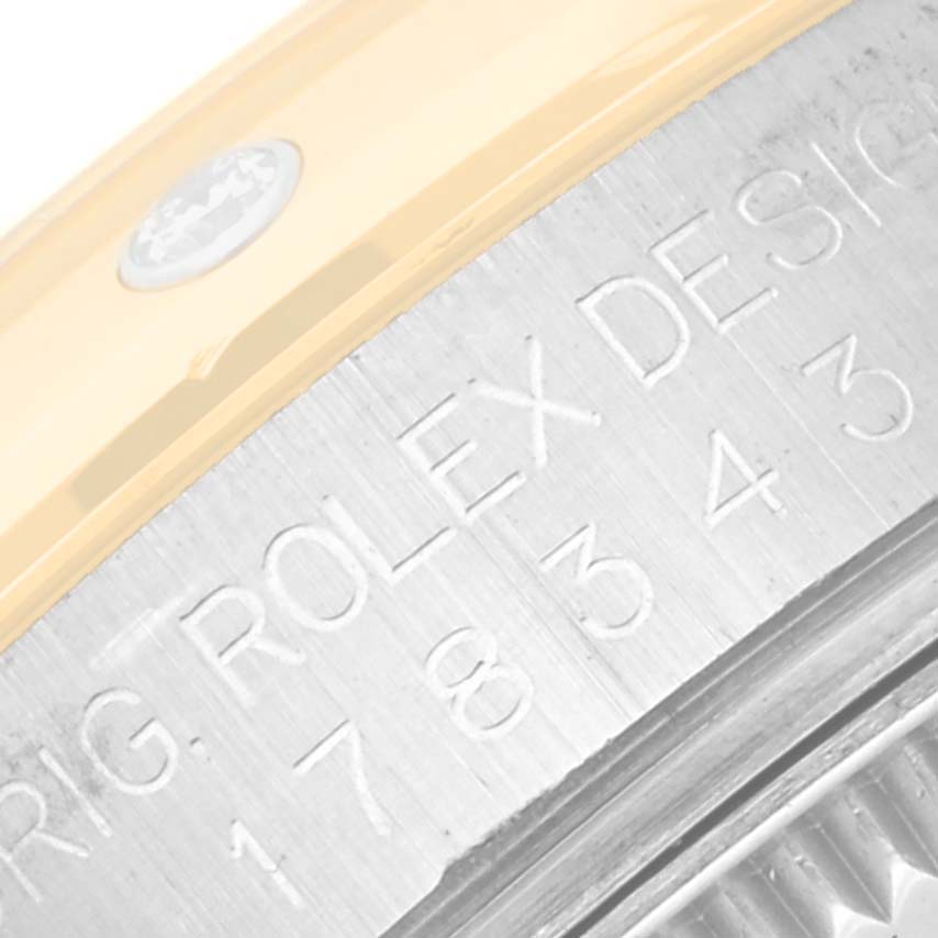 This image shows a close-up of the engraved rim on the casing of a Rolex Datejust 178343 Women's Steel and Gold (two tone) White Dial 178343 Women's Steel and Gold (two tone) White Dial watch.