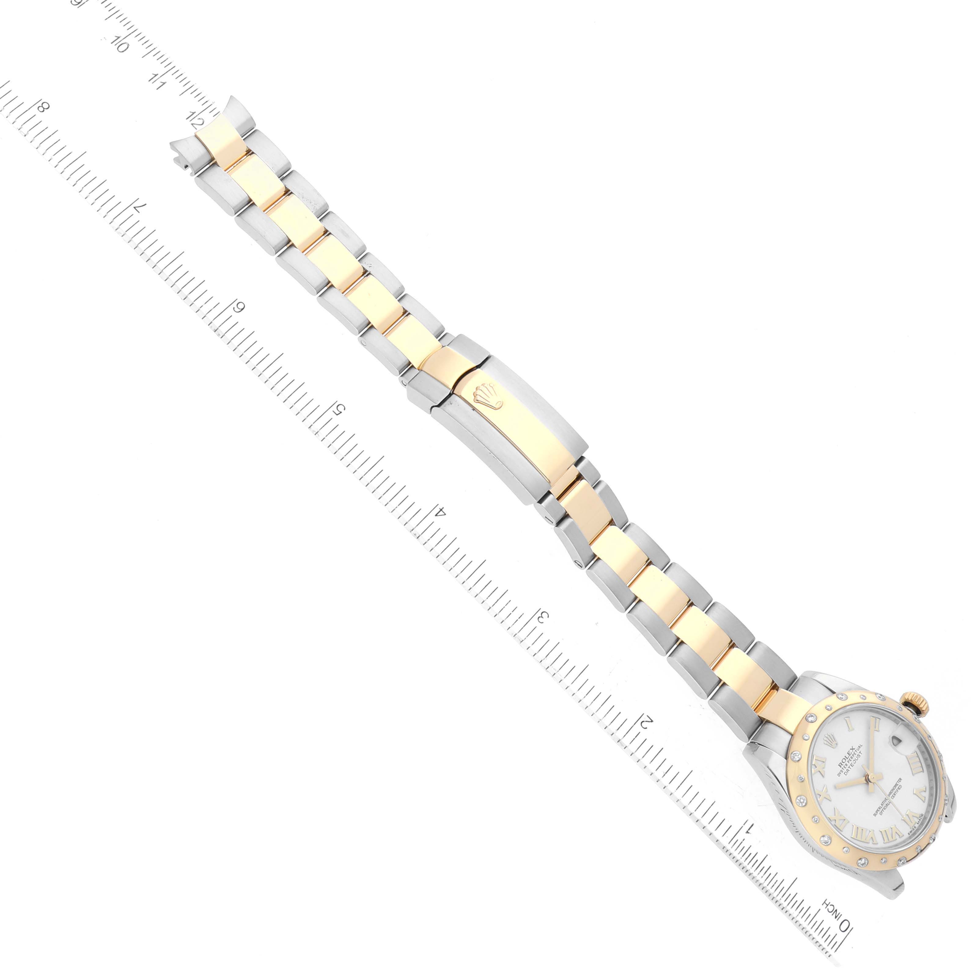 The image shows a top-down view of a Rolex Datejust 178343 Women's Steel and Gold (two tone) White Dial 178343 Women's Steel and Gold (two tone) White Dial watch, focusing on the bracelet and clasp alongside a ruler for scale.