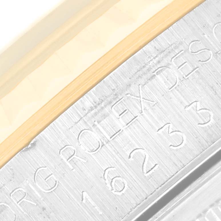 Close-up view of the Rolex Datejust 16233 Men's Steel and Gold (two tone) Black Dial 16233 Men's Steel and Gold (two tone) Black Dial's inner bezel and case side, showing engraved details.