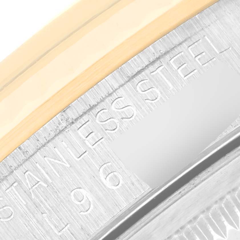 This image shows a close-up view of the stainless steel part and bezel edge of a Rolex Datejust 16233 Men's Steel and Gold (two tone) Black Dial 16233 Men's Steel and Gold (two tone) Black Dial watch.