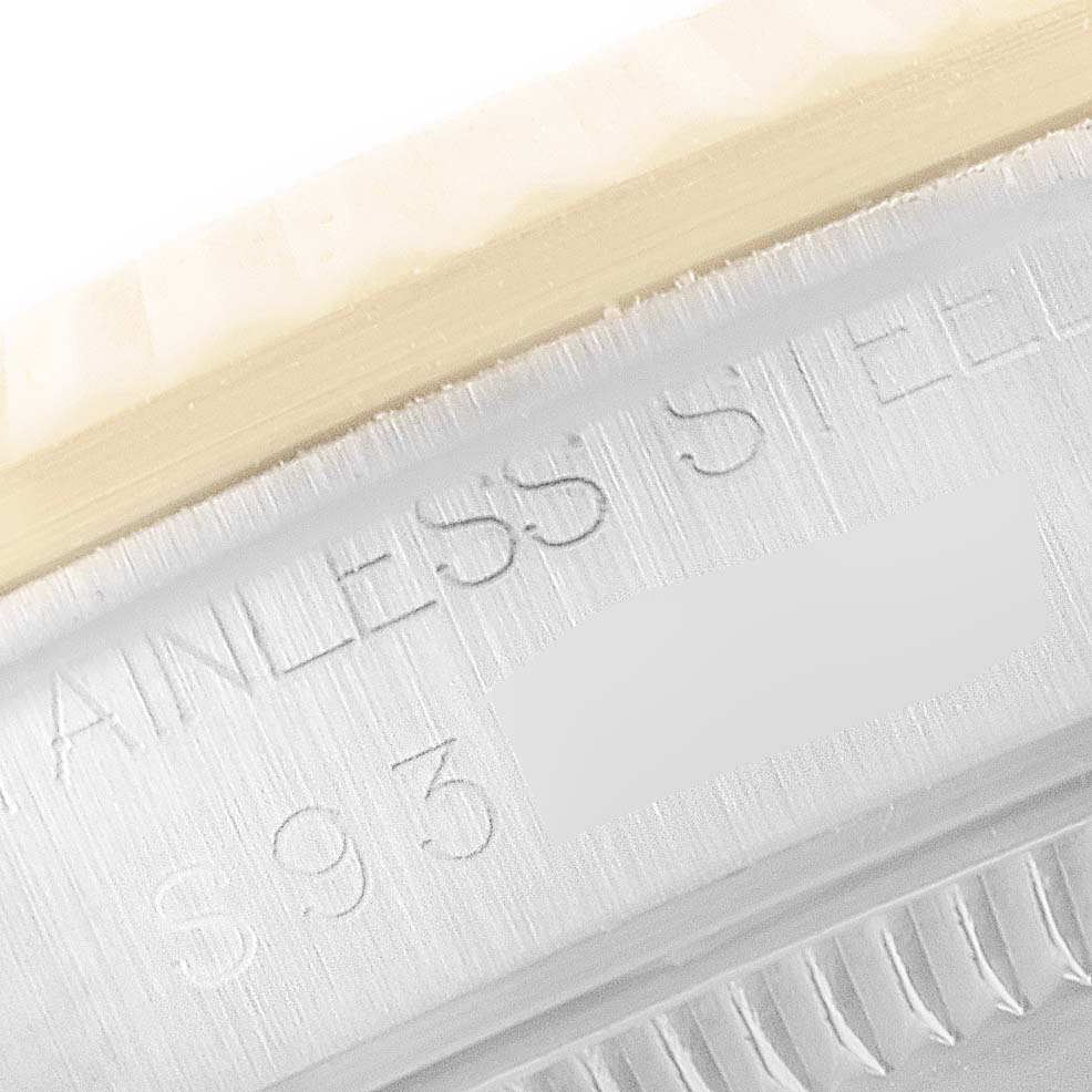 This close-up image shows the side engraving and part of the bezel of a Mid-Size Rolex watch, highlighting the "Stainless Steel" inscription.