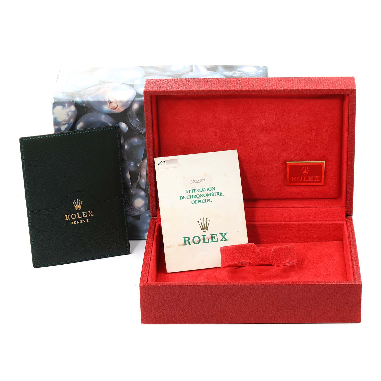 The image shows a red Rolex watch box, a certificate, and a green booklet for the Mid-Size Rolex model.