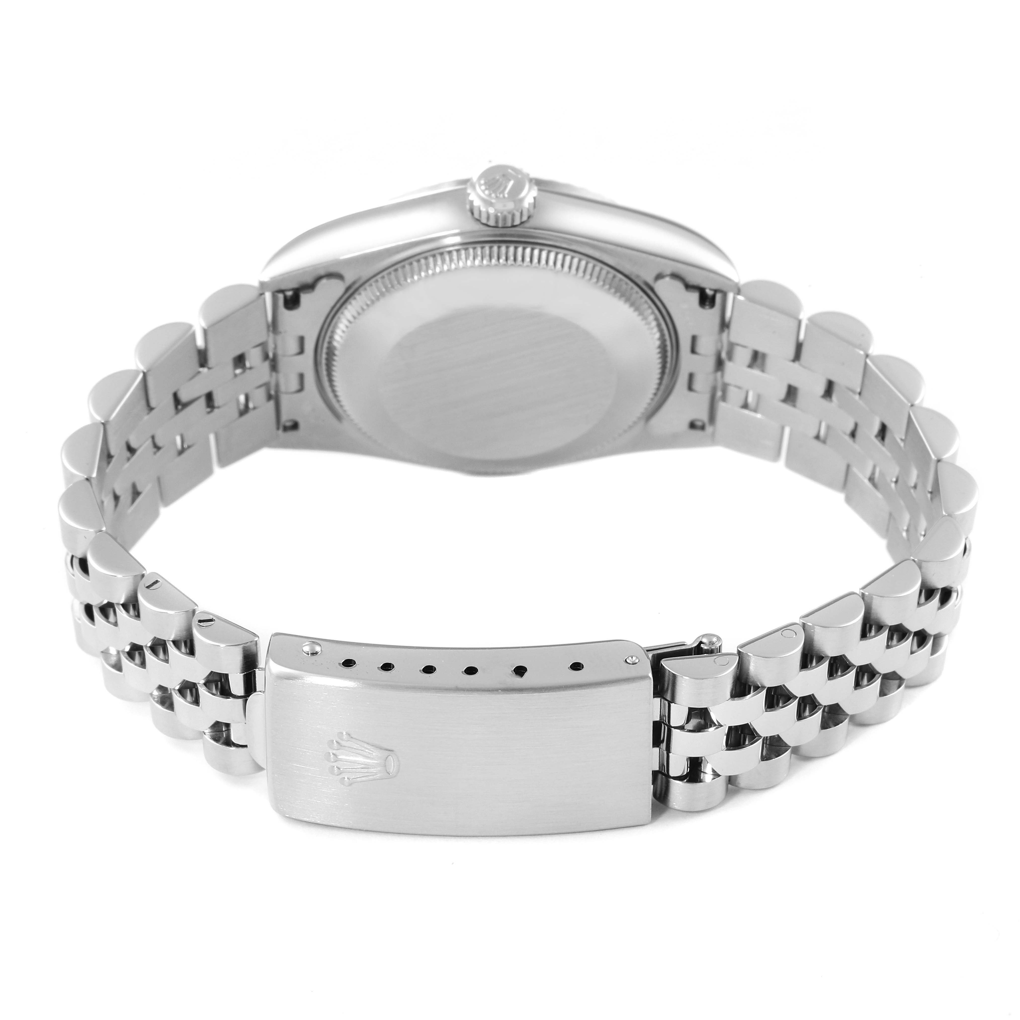 The image shows the back case, crown, and bracelet of a mid-size Rolex watch viewed from the rear angle.