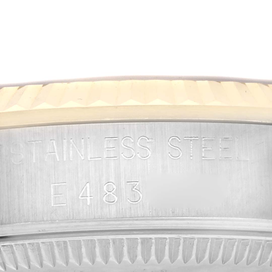 The image shows a close-up of the side of a Rolex Mid-Size 68273 Women's Steel and Gold (two tone) Black Dial 68273 Women's Steel and Gold (two tone) Black Dial watch, highlighting the stainless steel material and part of the fluted bezel.