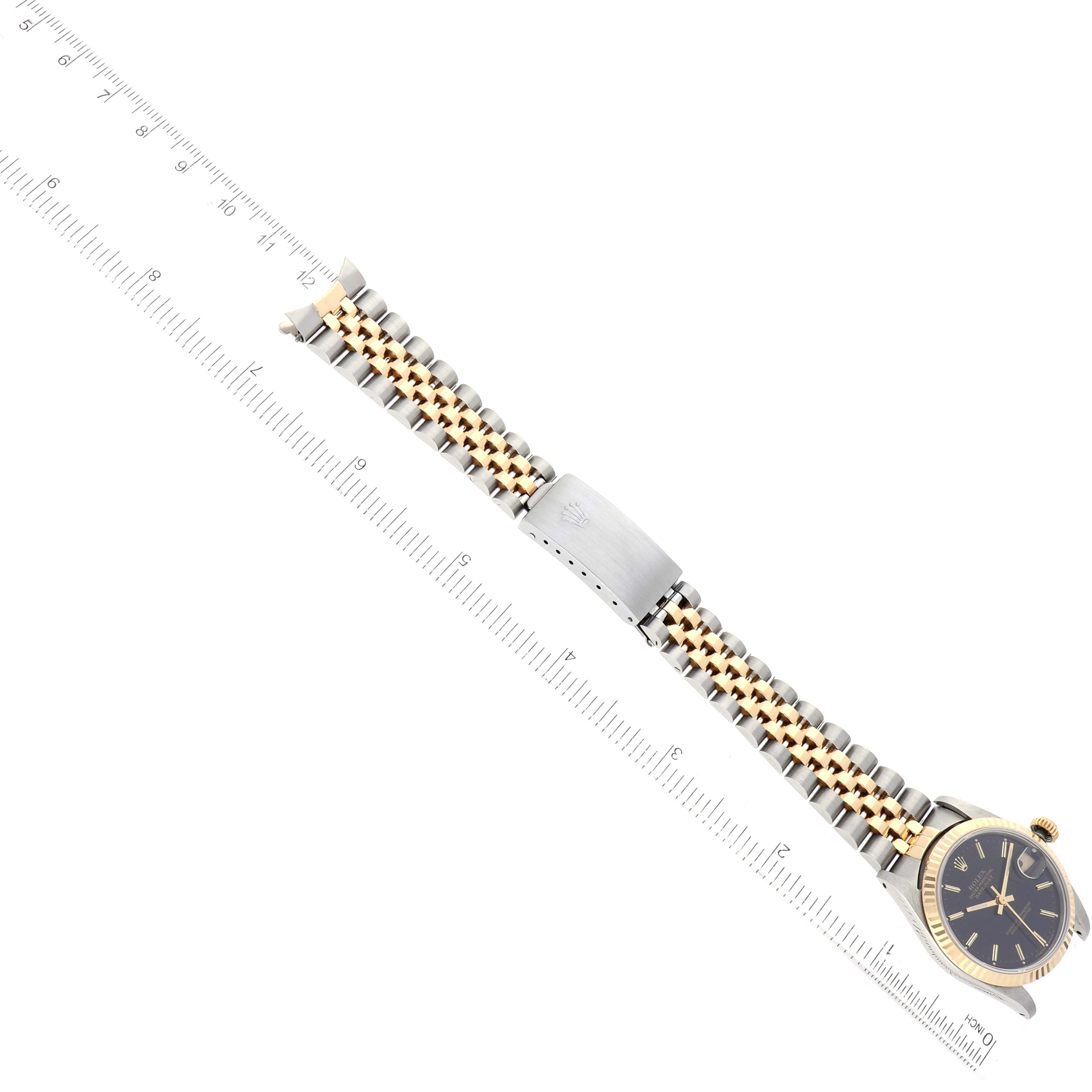 The image shows a Rolex Mid-Size 68273 Women's Steel and Gold (two tone) Black Dial 68273 Women's Steel and Gold (two tone) Black Dial watch laid flat, displaying the bracelet, clasp, and part of the dial, with a ruler for scale.