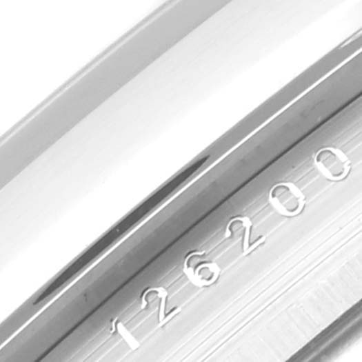 This image shows a close-up of the Rolex Datejust 126200 Men's Stainless Steel Green Dial 126200 Men's Stainless Steel Green Dial model 126200, focusing on the engraved serial number on the inner bezel.