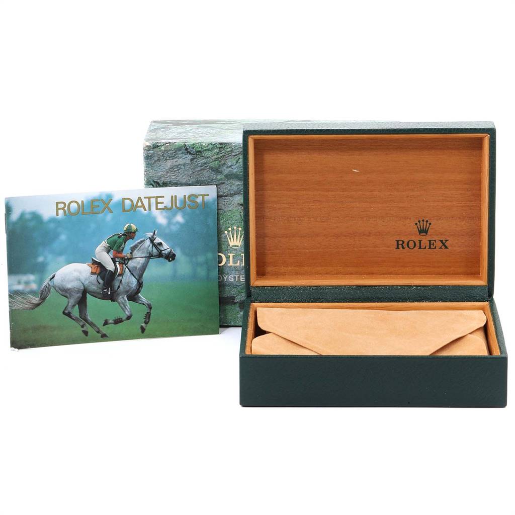 The image shows a Rolex Datejust 16233 Men
s Steel and Gold (two tone) Champagne Dial 16233 Men
s Steel and Gold (two tone) Champagne Dial watch box and an accompanying booklet at an angled view.