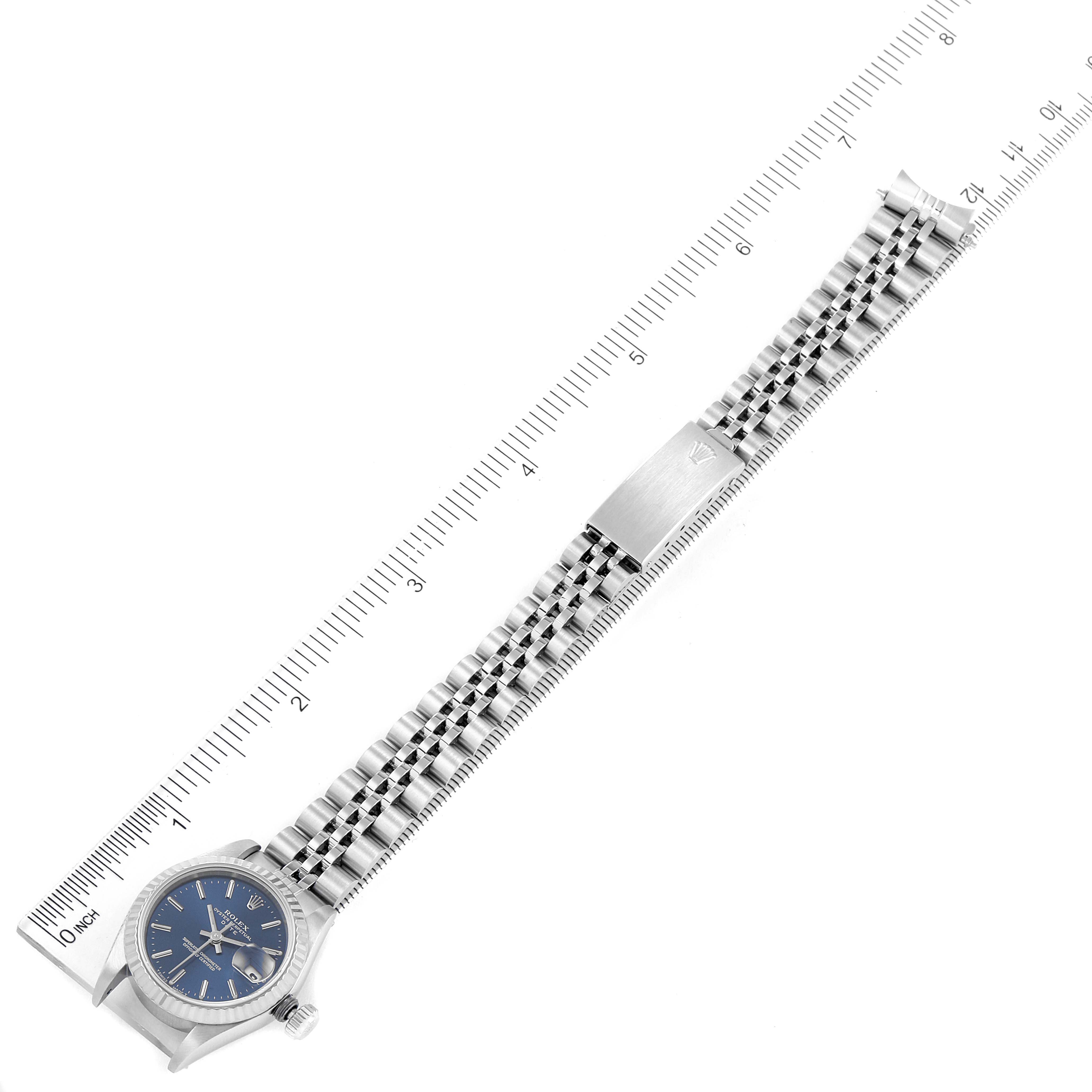 The image shows a Rolex Datejust 69174 Women's Stainless Steel Blue Dial 69174 Women's Stainless Steel Blue Dial watch laid flat with its face and bracelet fully visible, alongside a ruler for size reference.