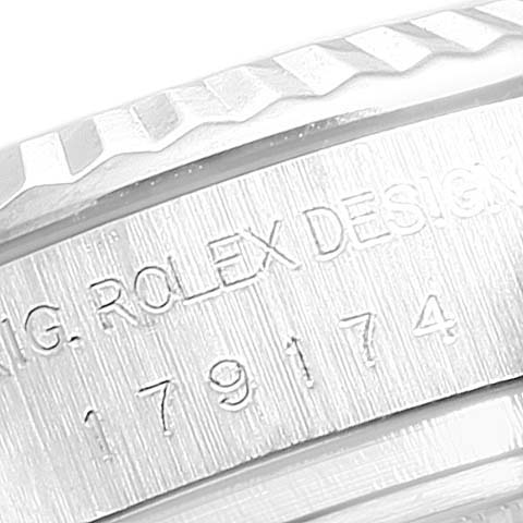 The image shows a close-up of the case side and bezel of a Rolex Datejust 179174 Women
s Stainless Steel Silver Dial 179174 Women
s Stainless Steel Silver Dial watch, featuring engravings.