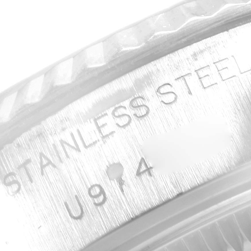 This image shows a close-up of the bezel and serial number engraving on a Rolex Datejust 69174 Women
s Stainless Steel Silver Dial 69174 Women
s Stainless Steel Silver Dial watch.