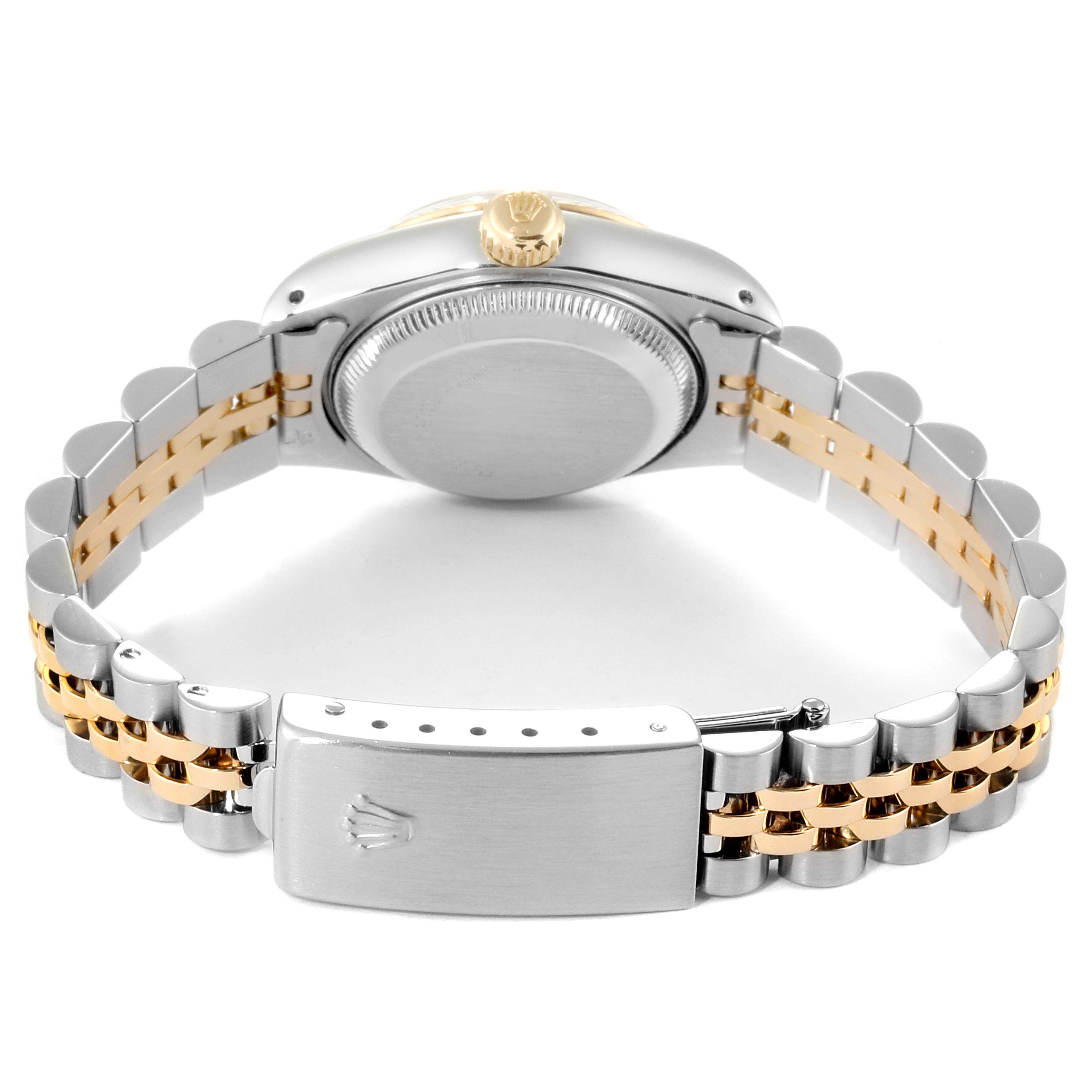 The back view of a Rolex Datejust 69173 Women
s Steel and Gold (two tone) Black Dial 69173 Women
s Steel and Gold (two tone) Black Dial watch features the case, crown, and two-tone bracelet with clasp.