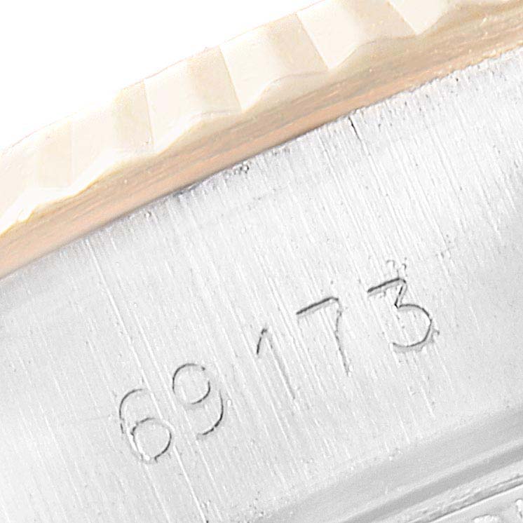 Close-up of the Rolex Datejust 69173 Women
s Steel and Gold (two tone) Black Dial 69173 Women
s Steel and Gold (two tone) Black Dial model showing the case
s edge and part of the fluted bezel with the model number 69173 engraved.