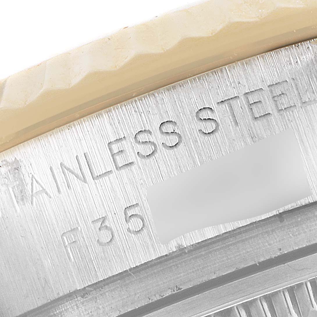 This image shows a close-up of the case back of the Rolex Datejust 179173 Women's Steel and Gold (two tone) Mother of Pearl Dial 179173 Women's Steel and Gold (two tone) Mother of Pearl Dial watch with engraved text.