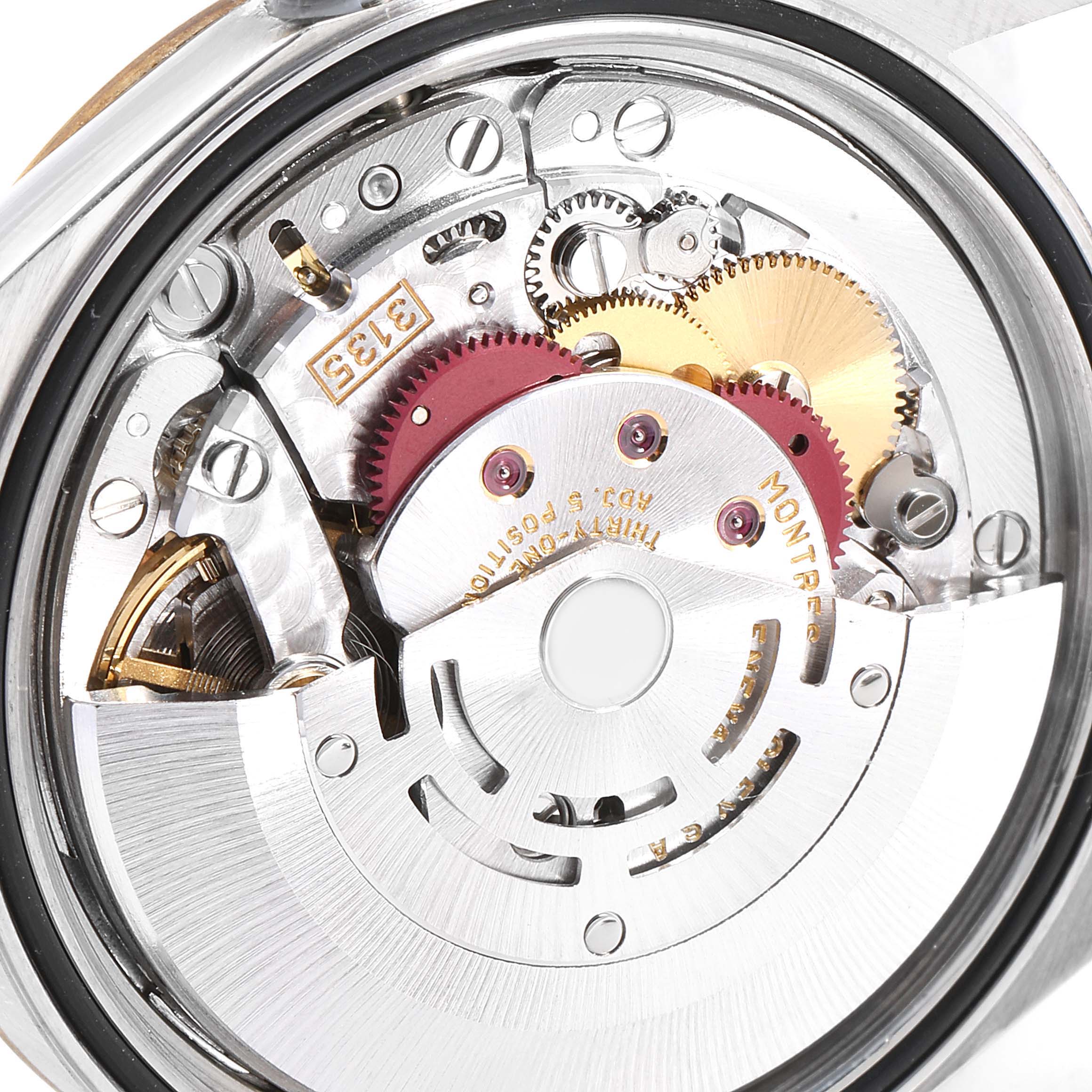 This image shows the intricate internal mechanism of a Rolex Datejust 16233 Men
s Steel and Gold (two tone) Silver Dial 16233 Men
s Steel and Gold (two tone) Silver Dial watch from the back angle, highlighting the gears and movement components.