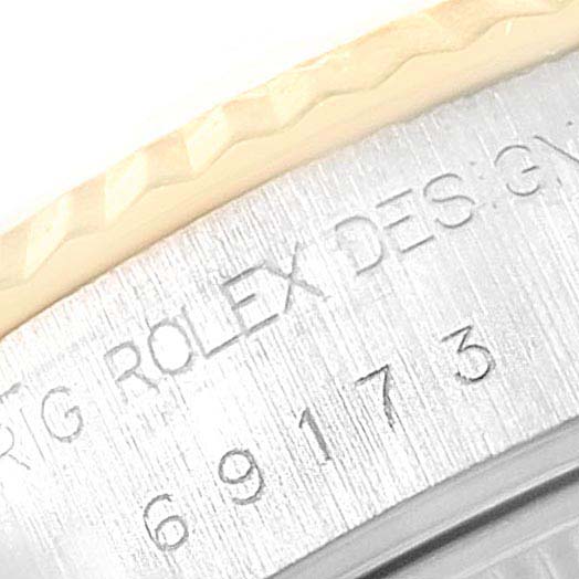 The image shows a close-up of the engraved side of the Rolex Datejust 69173 Women
s Steel and Gold (two tone) White Dial 69173 Women
s Steel and Gold (two tone) White Dial watch case, highlighting the model and serial numbers.