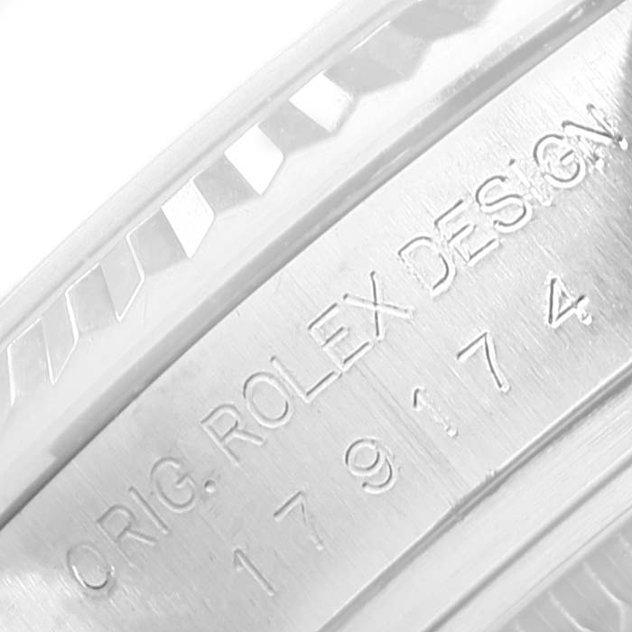 This image shows a close-up of the engraved serial number and "Rolex Design" on the Rolex Datejust 179174 Women's Stainless Steel Silver Dial 179174 Women's Stainless Steel Silver Dial model watch case.