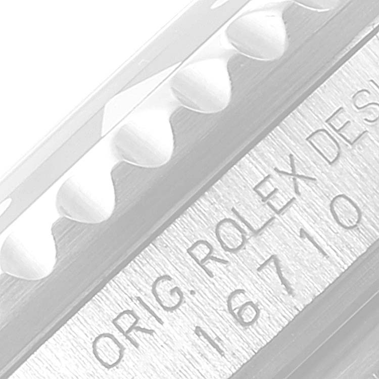 The image shows a close-up angle of the engraved serial number on the case of a Rolex GMT-Master 16710 Men
s Stainless Steel Black Dial 16710 Men
s Stainless Steel Black Dial watch, model 16710.