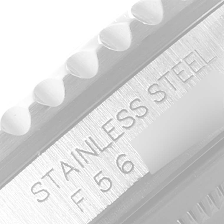 The image shows a close-up of the side of a Rolex GMT-Master 16710 Men
s Stainless Steel Black Dial 16710 Men
s Stainless Steel Black Dial, focusing on the stainless steel engraved part of the bezel.