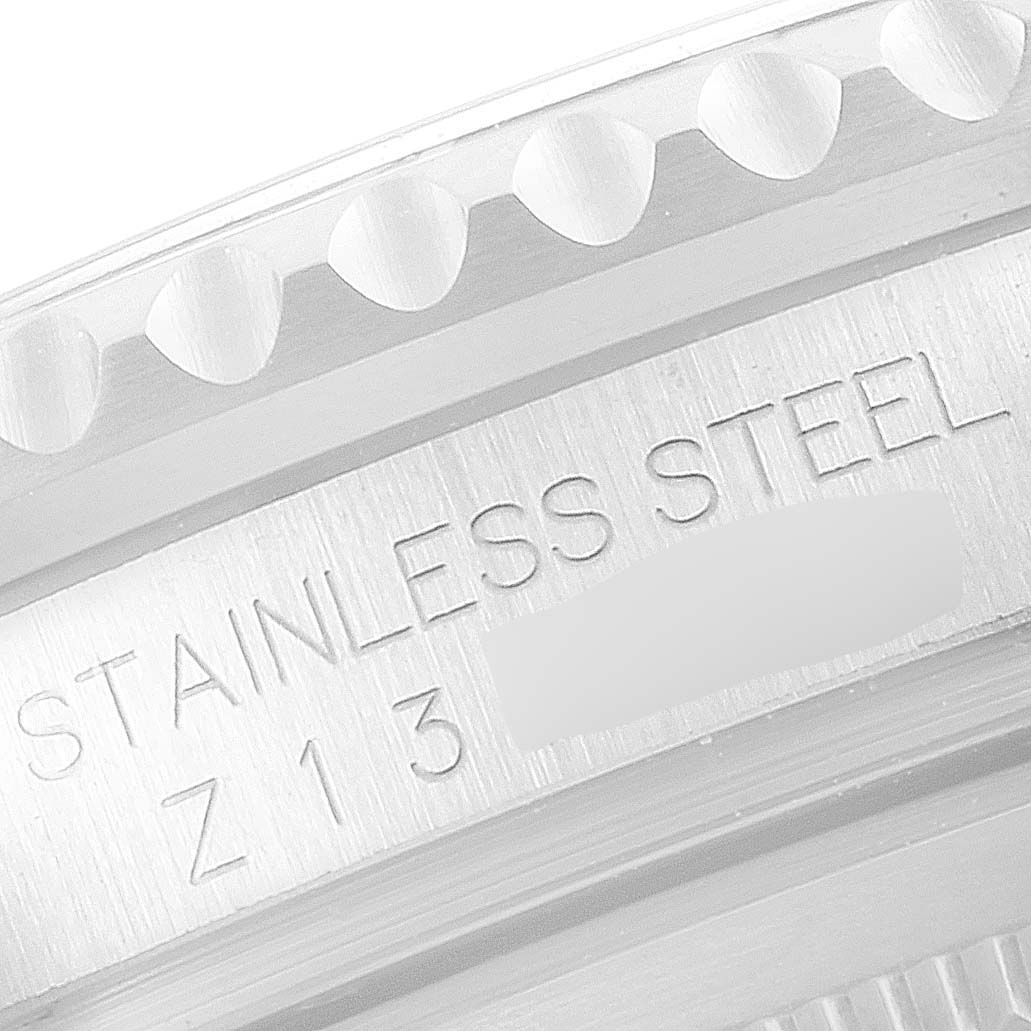 This image shows a close-up of the stainless steel bezel and engraving of a Rolex GMT-Master 16710 Men's Stainless Steel Black Dial 16710 Men's Stainless Steel Black Dial watch.