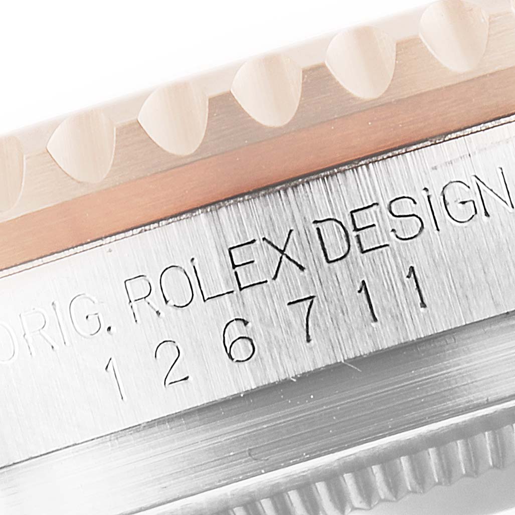 This close-up image shows part of the bezel and case, including the model number 126711 of the Rolex GMT-Master 126711 Men
s Stainless Steel Black Dial 126711 Men
s Stainless Steel Black Dial watch.