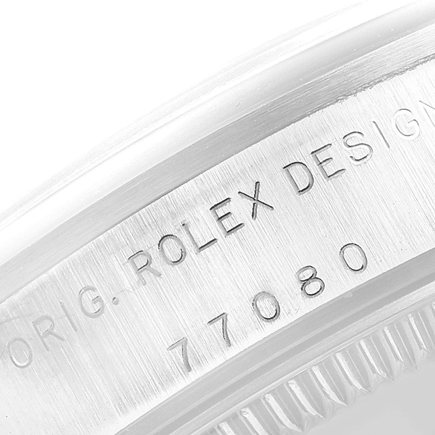 This image shows a close-up of the engraved side of the bezel of a Mid-Size Rolex watch model 77080.