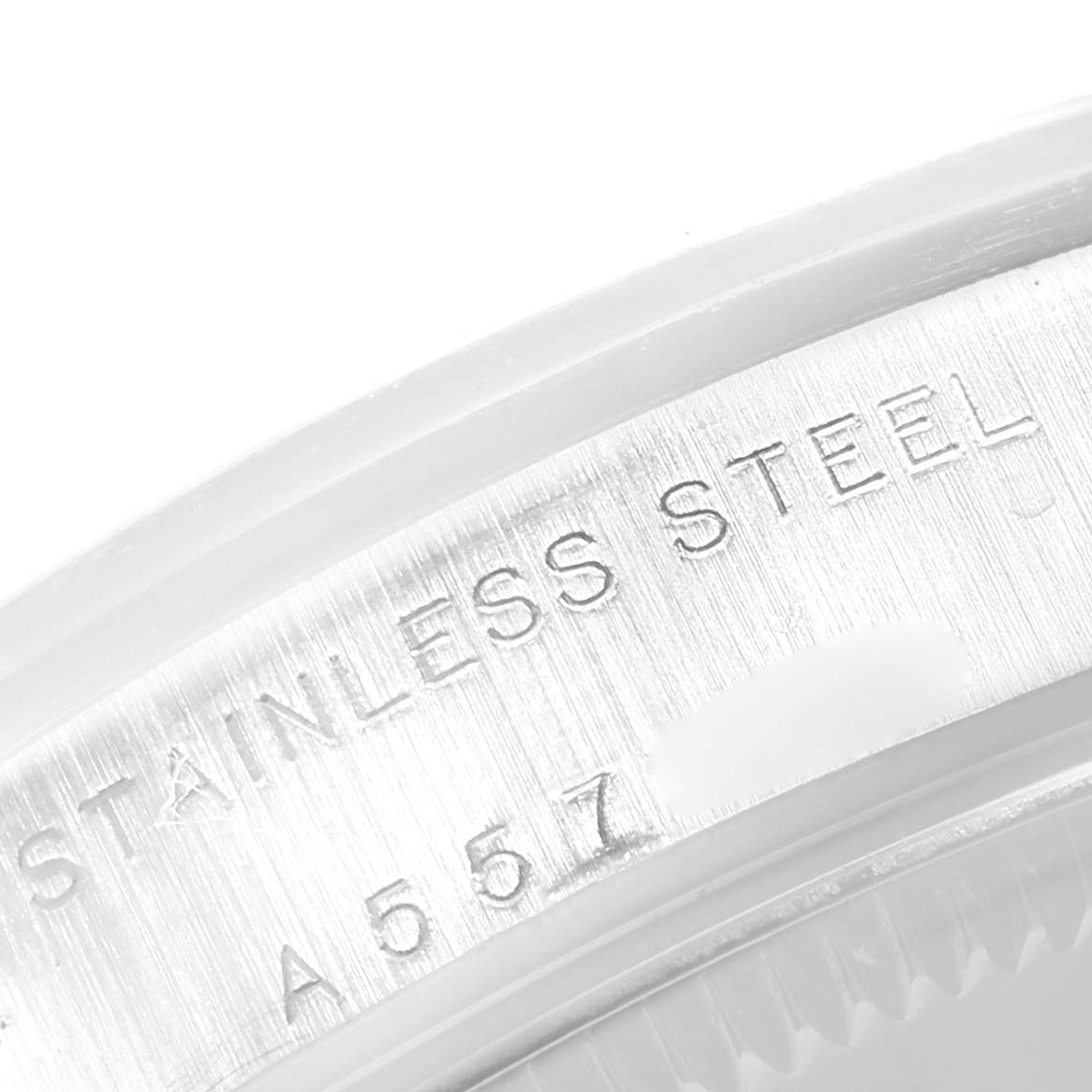 The image shows a close-up of the stainless steel casing with serial number engraving of a Rolex Mid-Size 77080 Women's Stainless Steel Silver Dial 77080 Women's Stainless Steel Silver Dial watch.