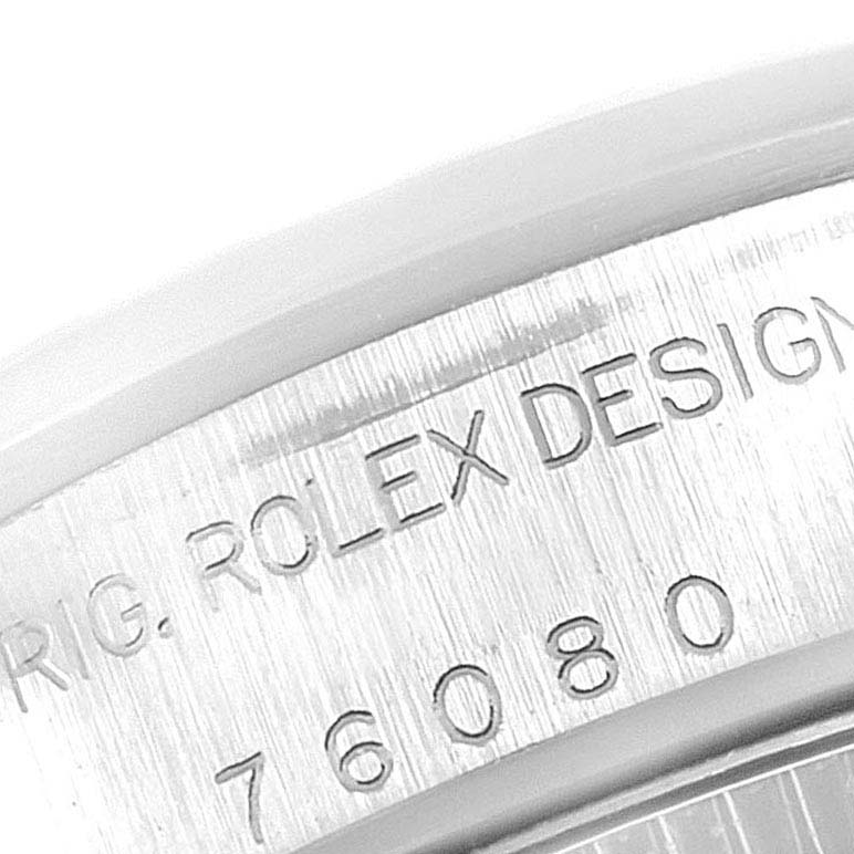 This close-up shows the engraved serial number and "ROLEX DESIGN" on the side of the Rolex Oyster Perpetual 76080  Women's Stainless Steel Pink Dial 76080  Women's Stainless Steel Pink Dial watch case.