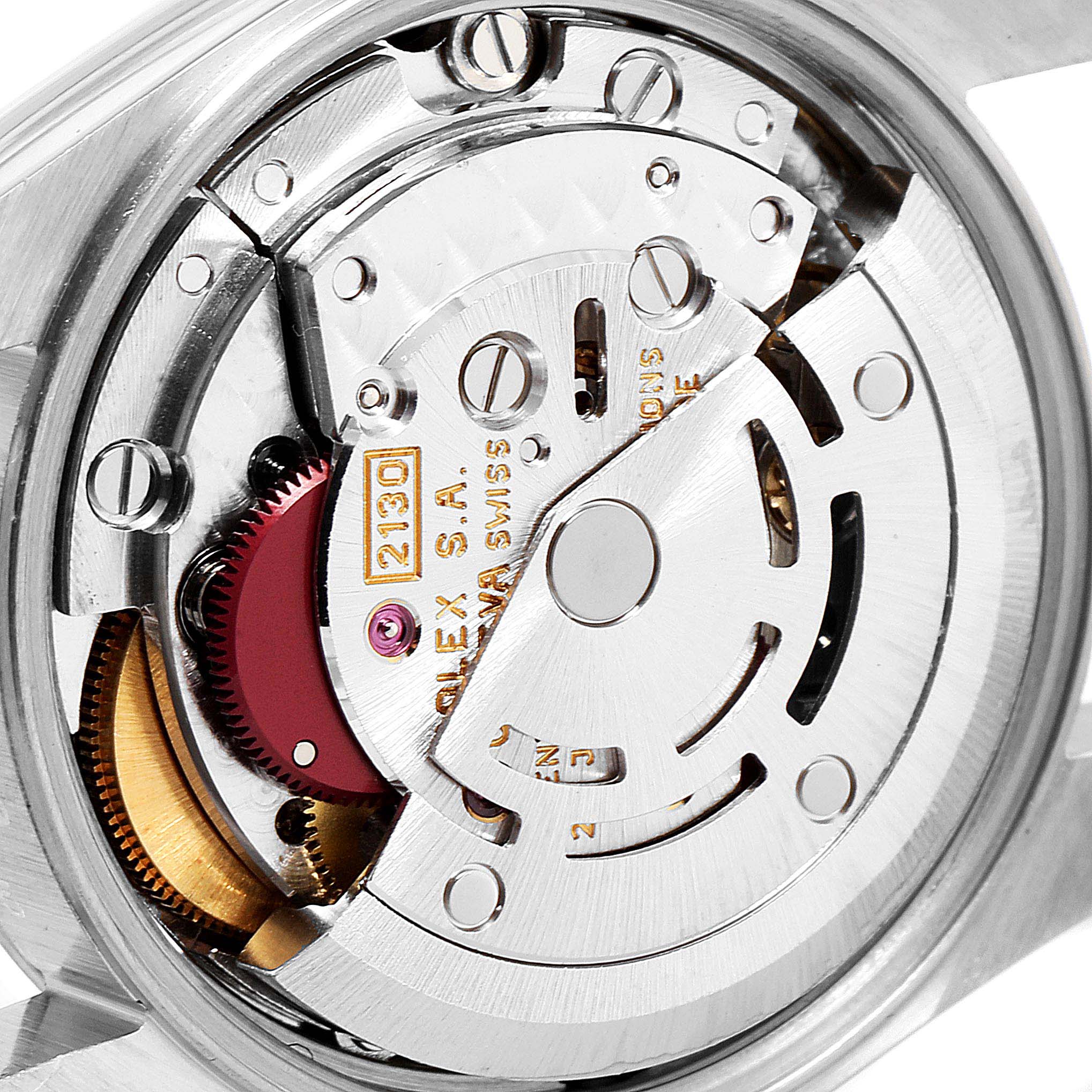 The image shows the movement mechanism of a Rolex Oyster Perpetual 67180 Women
s Stainless Steel Black Dial 67180 Women
s Stainless Steel Black Dial watch from a close-up, detailed angle.