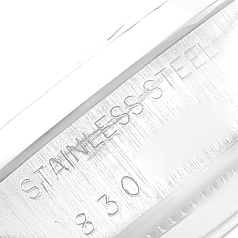 The image shows a close-up of the case side engraving on a Rolex Date 6694 Men's Stainless Steel Black Dial 6694 Men's Stainless Steel Black Dial model, indicating "Stainless Steel" and the number 830.