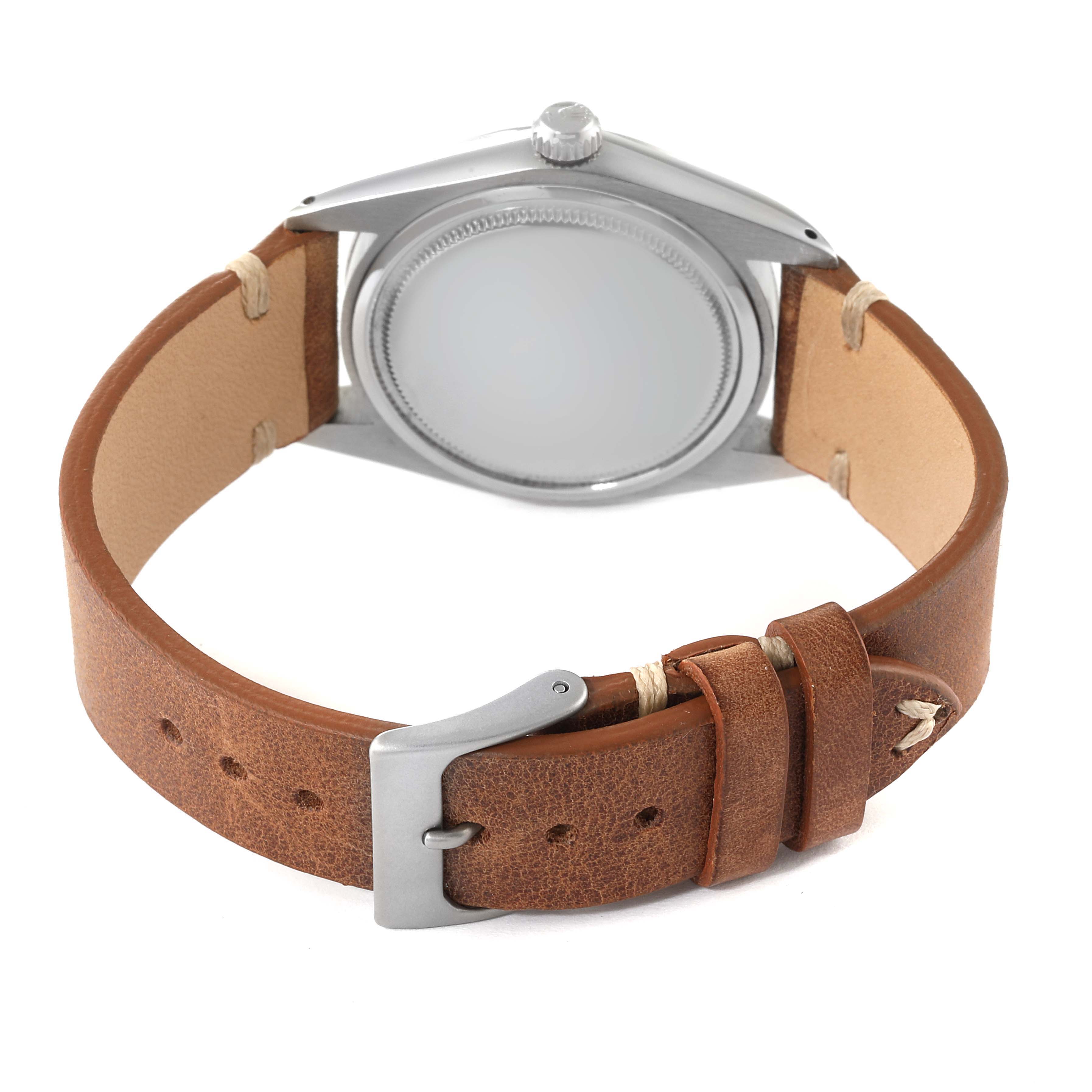 The image shows a Rolex Date 6694 Men's Stainless Steel Silver Dial 6694 Men's Stainless Steel Silver Dial model watch from the back, highlighting its case back and brown leather strap with buckle.