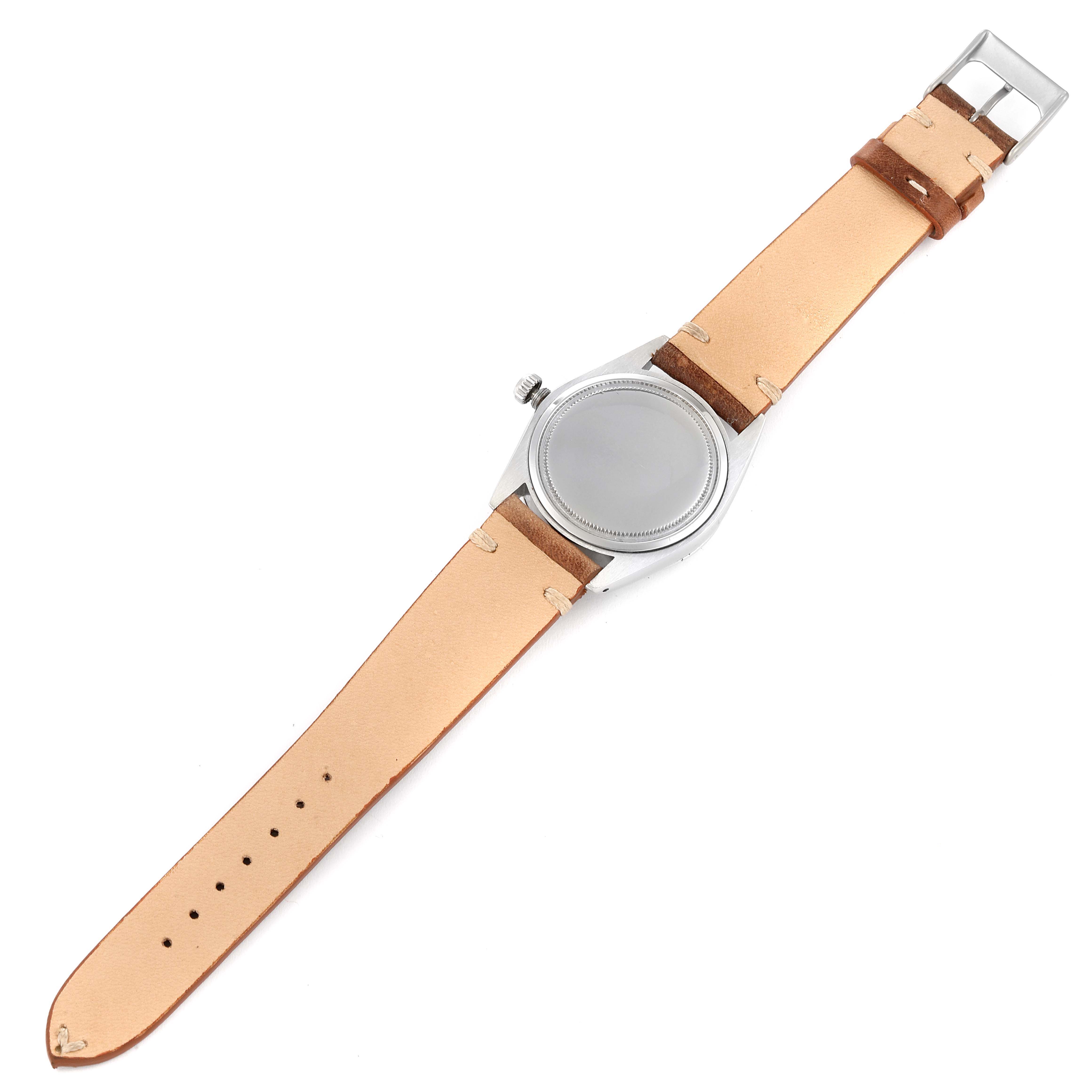 The image shows a top-down view of a Rolex Date 6694 Men's Stainless Steel Silver Dial 6694 Men's Stainless Steel Silver Dial model watch with a light brown leather strap.