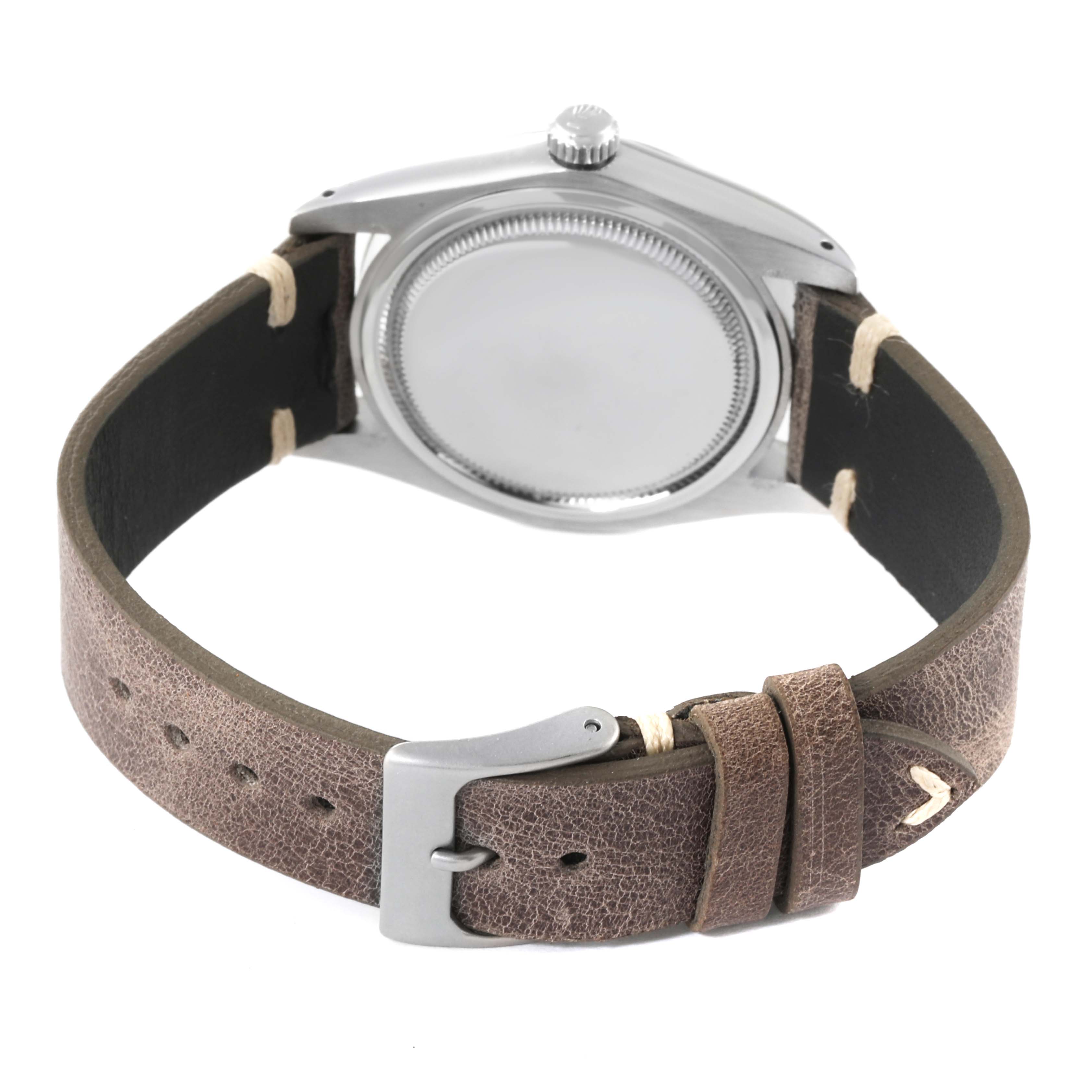 The image shows the back view of a Rolex Date 6694 Men's Stainless Steel Silver Dial 6694 Men's Stainless Steel Silver Dial model watch with a brown leather strap and silver buckle.