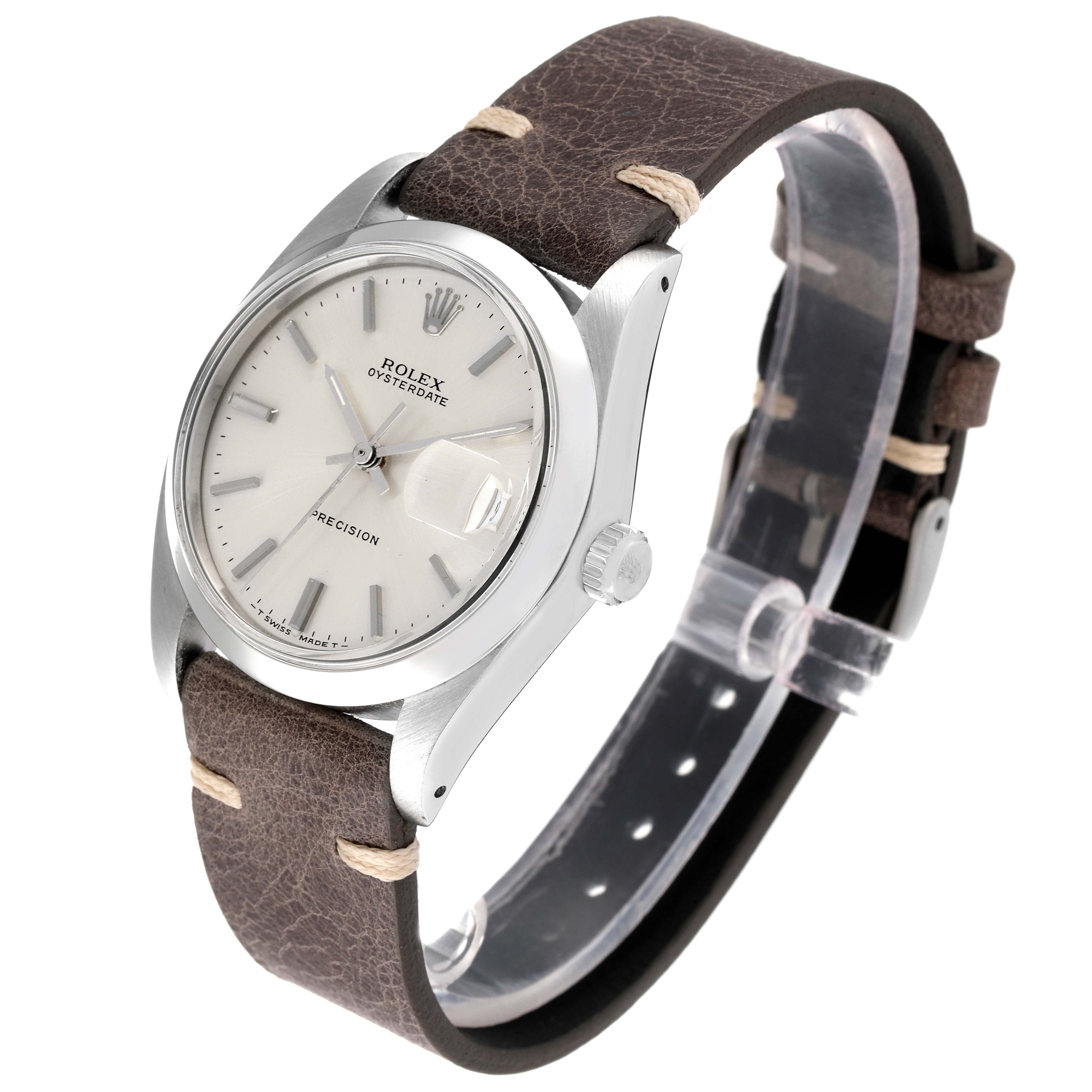The image shows a Rolex Date 6694 Men's Stainless Steel Silver Dial 6694 Men's Stainless Steel Silver Dial model watch, highlighting its dial, bezel, case, crown, and brown leather strap at an angled view.