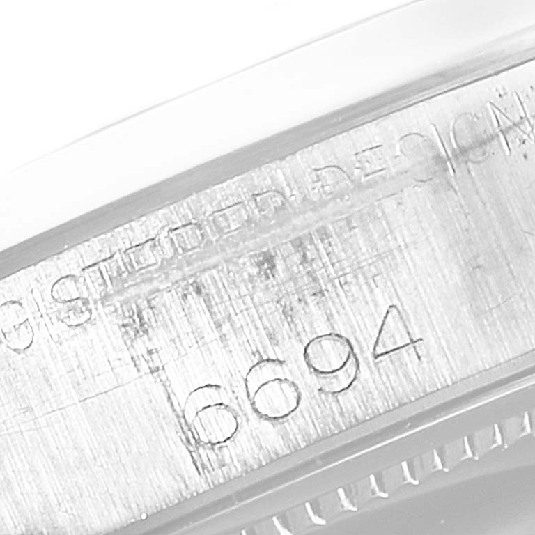 This close-up image shows the engraved model number "6694" on the side case of a Rolex Date 6694 Men's Stainless Steel Silver Dial 6694 Men's Stainless Steel Silver Dial watch.