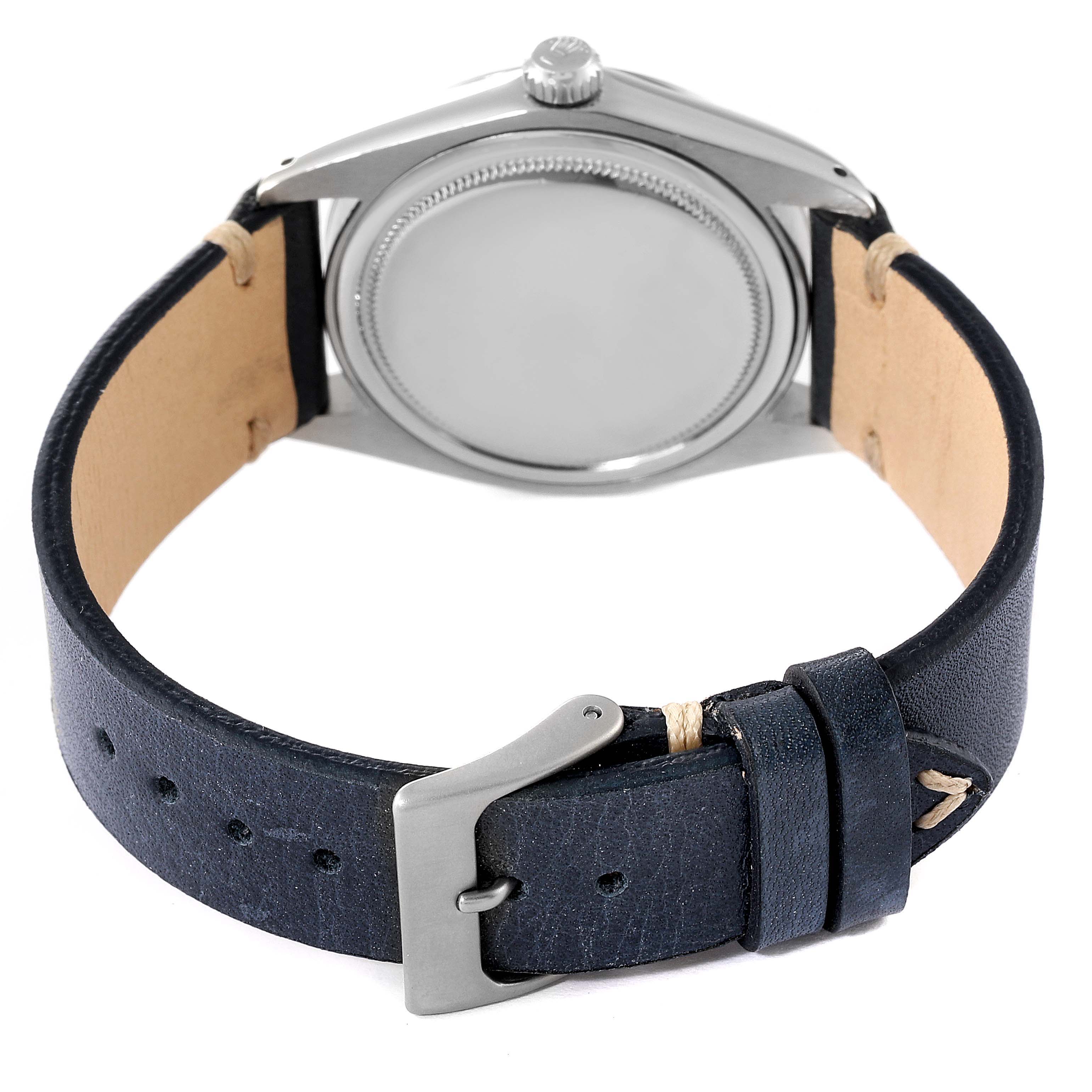 The image shows the back view of a Rolex Date 6694 Men's Stainless Steel Silver Dial 6694 Men's Stainless Steel Silver Dial watch with its case, crown, and leather strap.