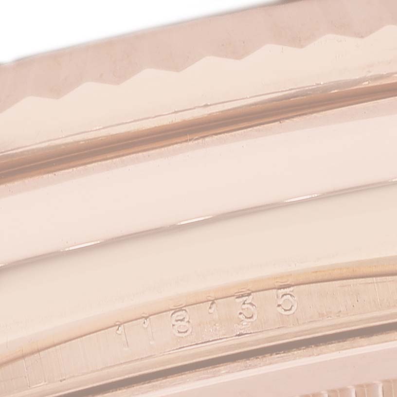 The image shows a close-up of the Rolex President 118135 Men's Rose Gold Brown Dial model's bezel and serial number, angled to highlight the engraving.