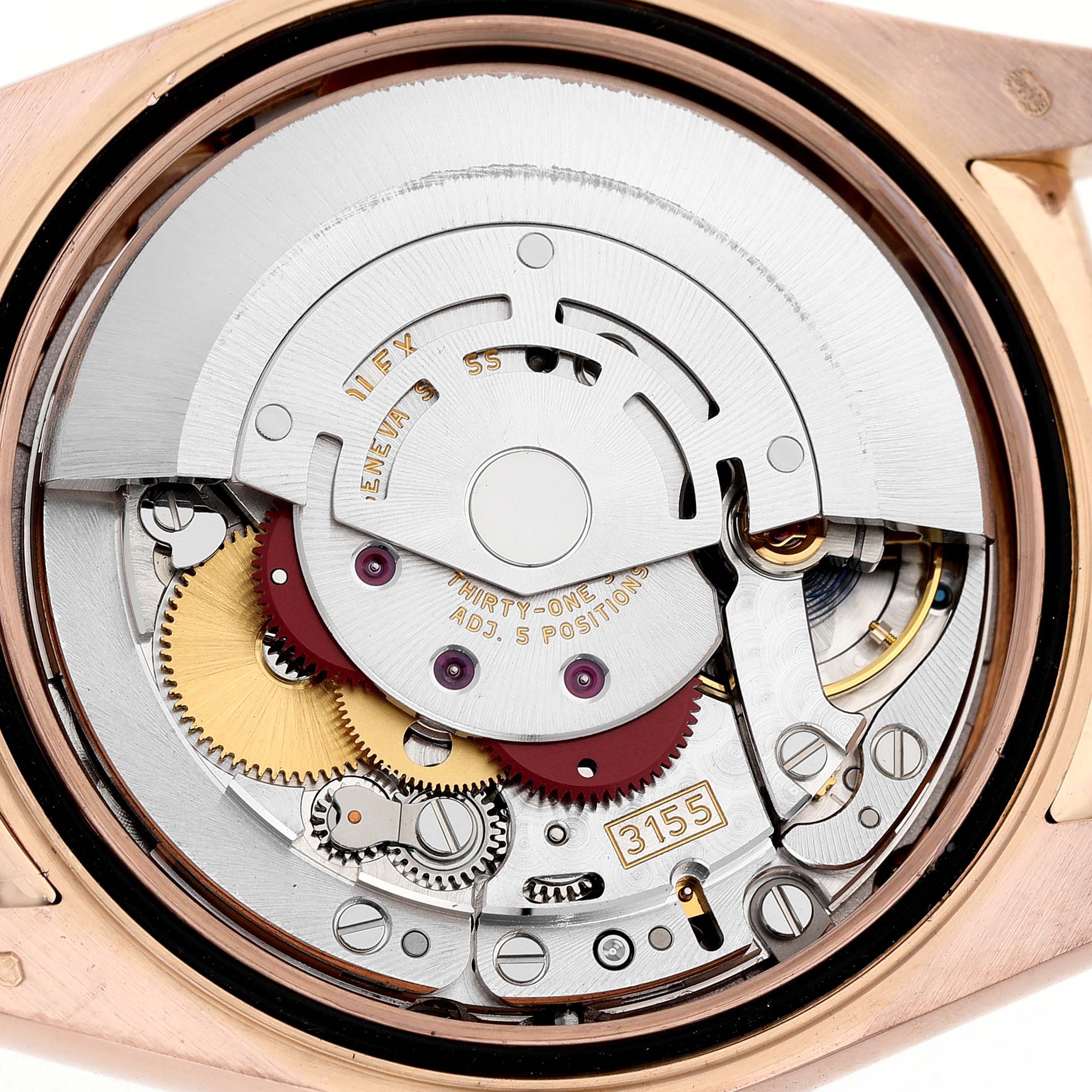 The image shows the mechanical movement of a Rolex President 118135 Men's Rose Gold Brown Dial watch from a top-down angle, highlighting gears and components.