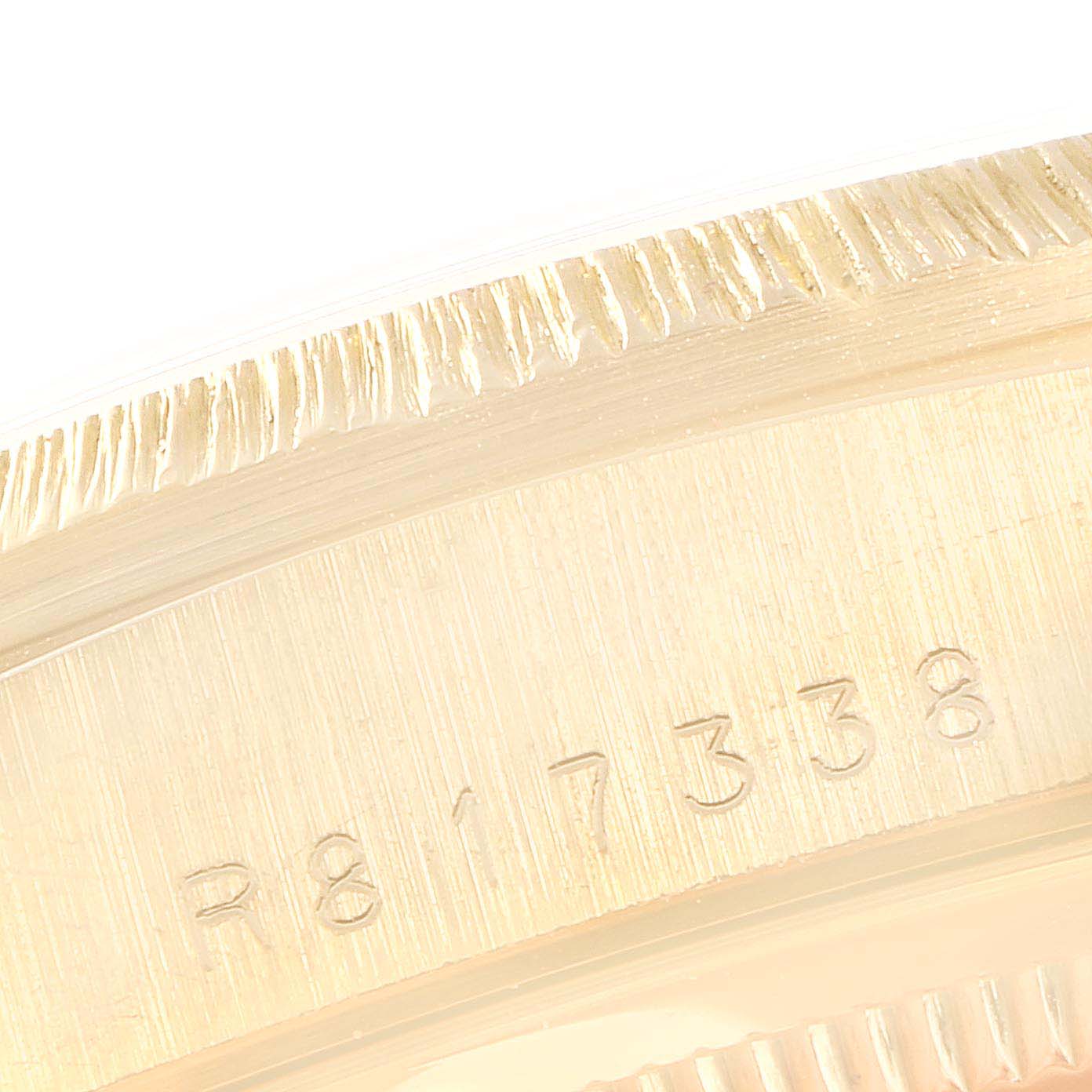 This close-up image shows a partial view of the bezel and engraved serial number of a Rolex President 18248 Men
s Yellow Gold Silver Dial 18248 Men
s Yellow Gold Silver Dial model watch.