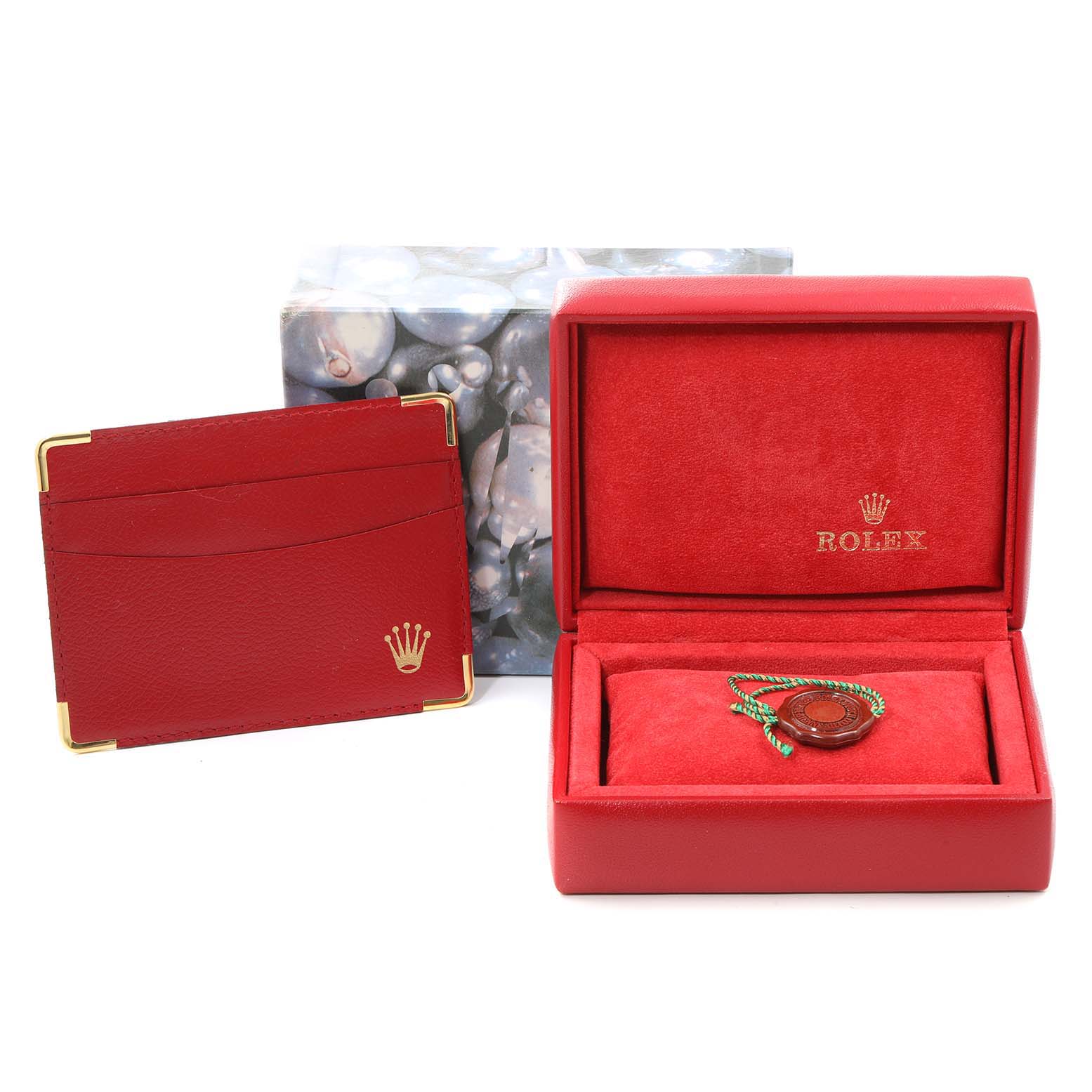 The image shows the red presentation box and cardholder for the Rolex President 79138 Women
s Yellow Gold Mother of Pearl Dial 79138 Women
s Yellow Gold Mother of Pearl Dial model watch.