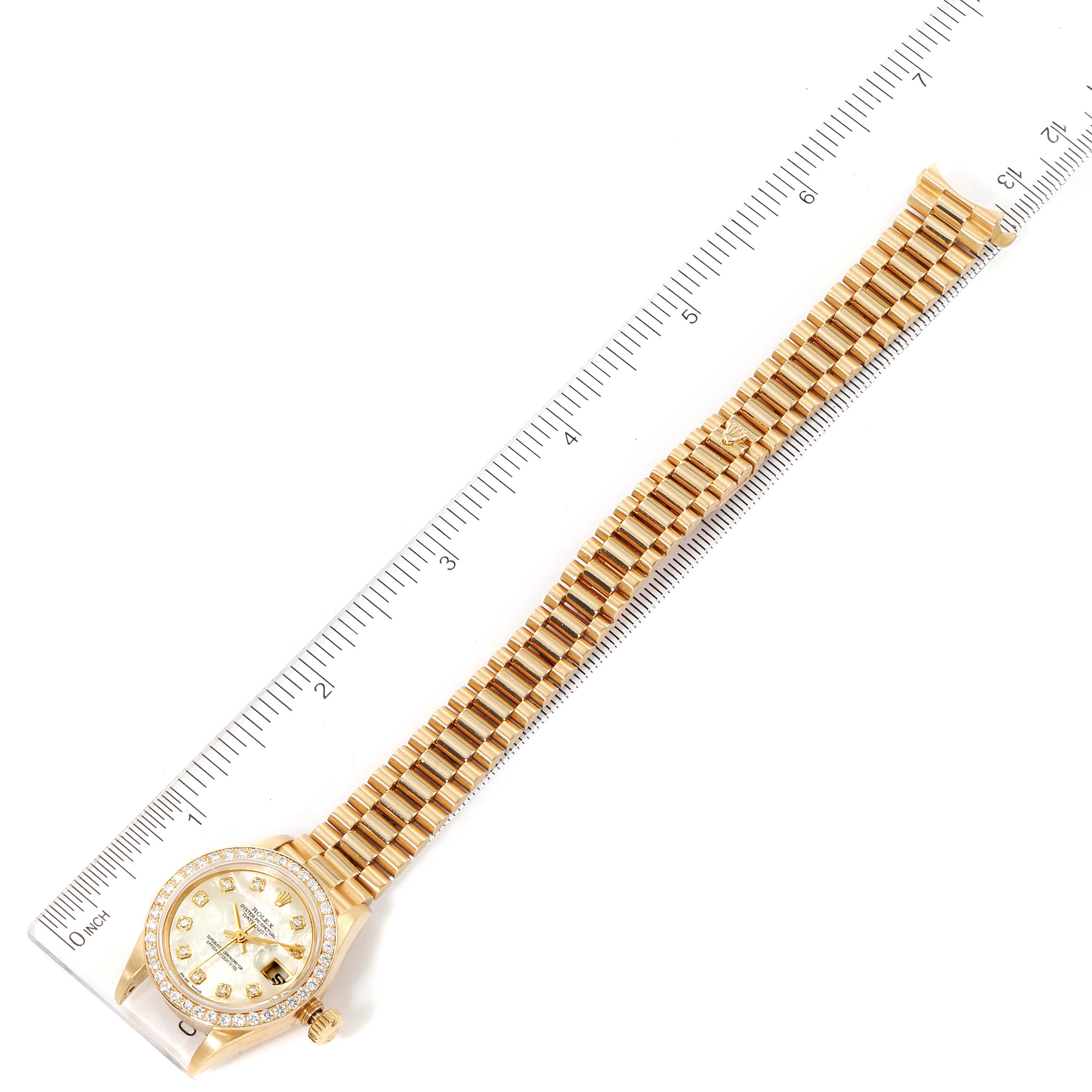 The image shows an overhead view of a Rolex President 79138 Women
s Yellow Gold Mother of Pearl Dial 79138 Women
s Yellow Gold Mother of Pearl Dial model watch, displaying the full length of the bracelet and the watch face.