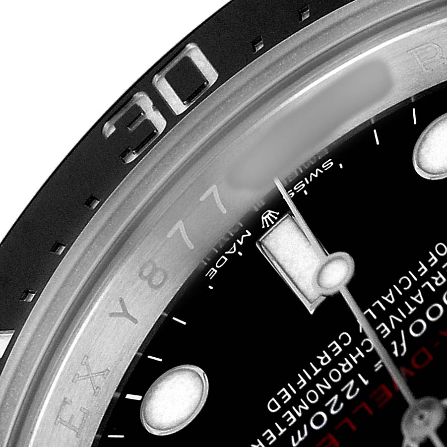 The image shows a close-up of the dial and bezel of a Rolex Sea-Dweller 126600 Men's Stainless Steel Black Dial, highlighting the indices and textual details.