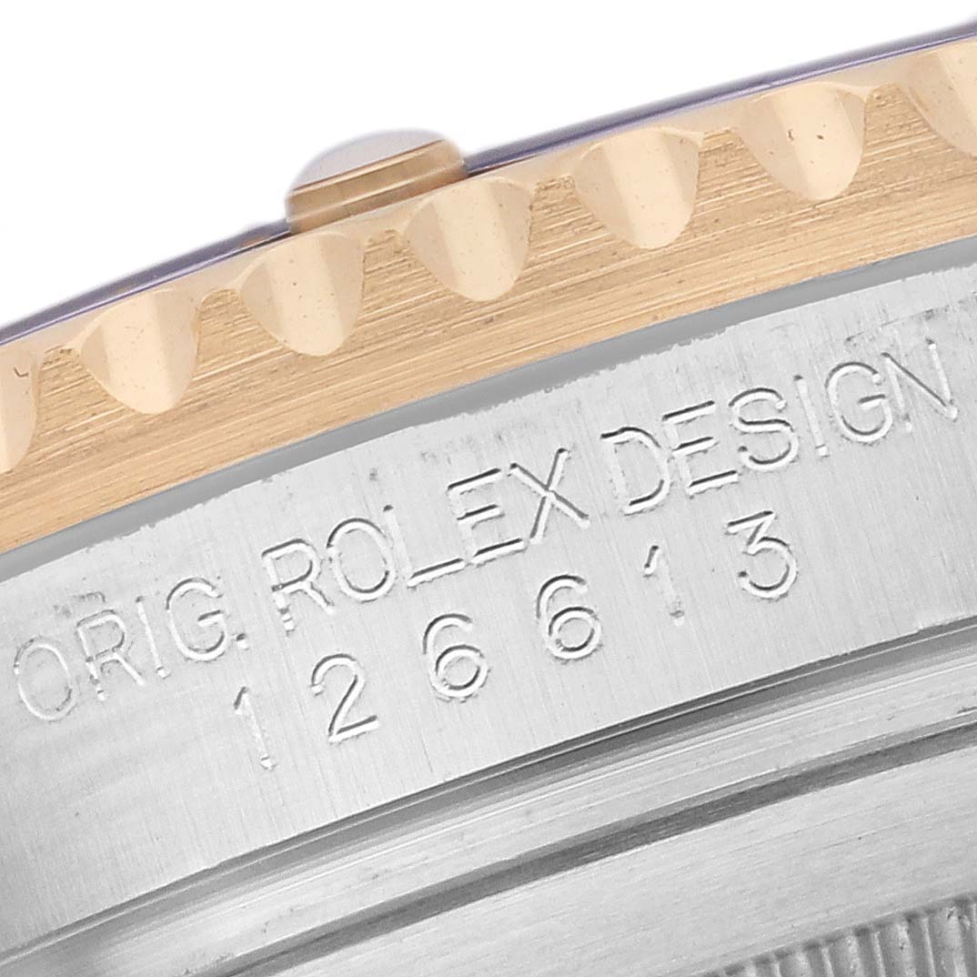 Close-up of the bezel and engraved case side, showing model number 126613 on a Rolex Submariner 126613 Men's Steel and Gold (two tone) Blue Dial 126613 Men's Steel and Gold (two tone) Blue Dial.