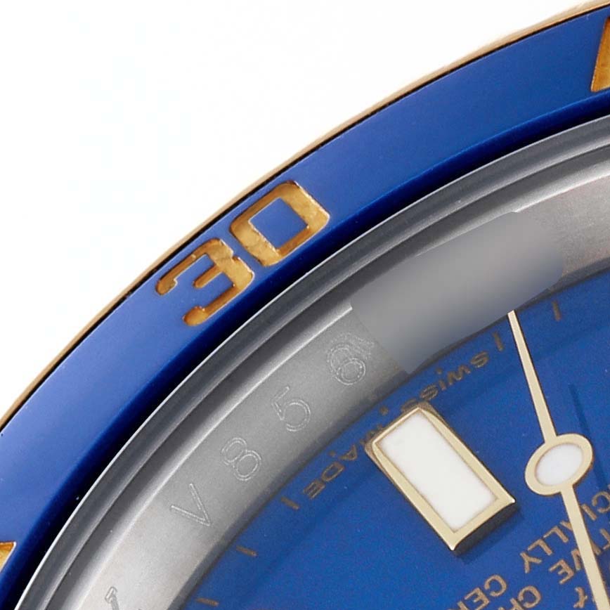 Close-up angle showing the bezel, dial, and part of the minute hand of the Rolex Submariner 116613 Men's Steel and Gold (two tone) Blue Dial 116613 Men's Steel and Gold (two tone) Blue Dial watch.