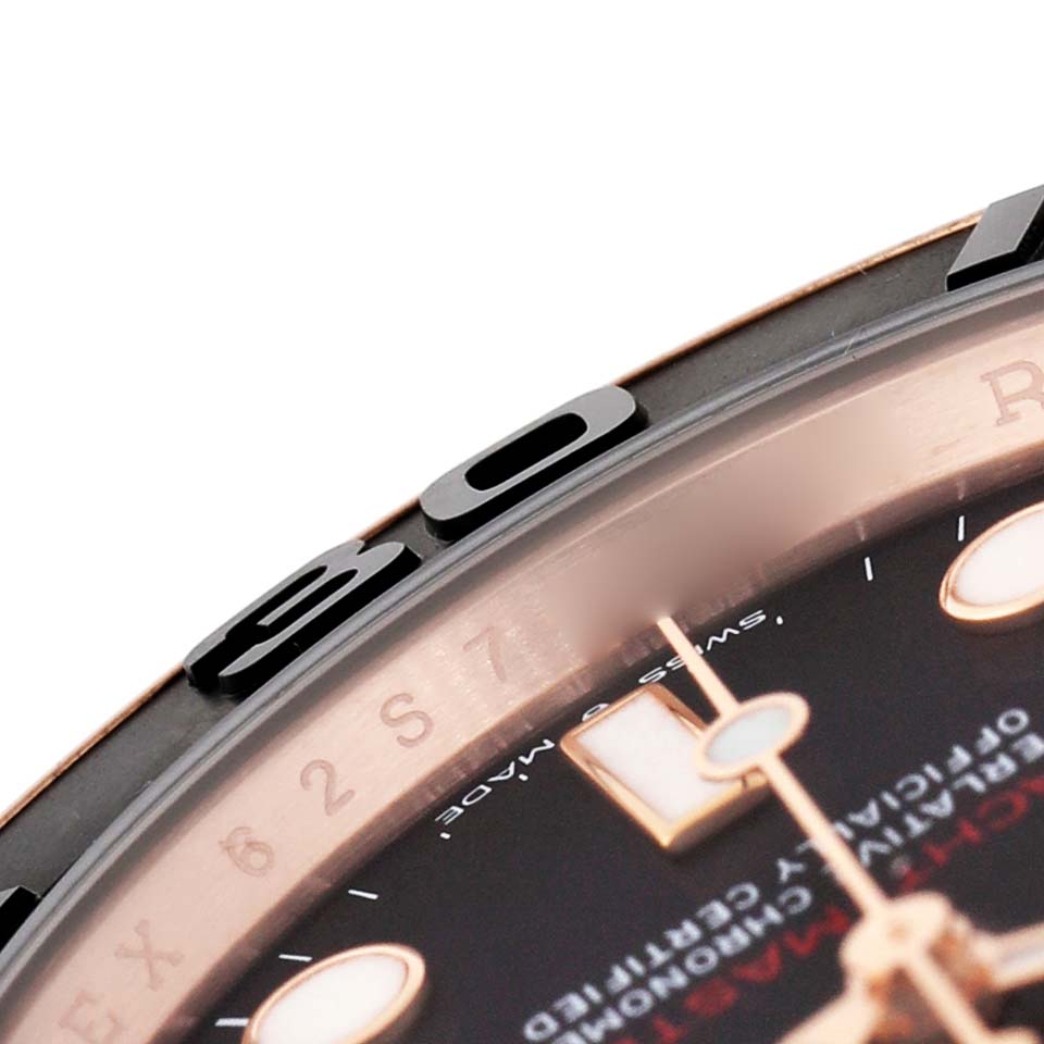 The image shows a close-up of the bezel, part of the dial, and some markers of the Rolex Yacht-Master 126655 Men's Rose Gold Black Dial watch.