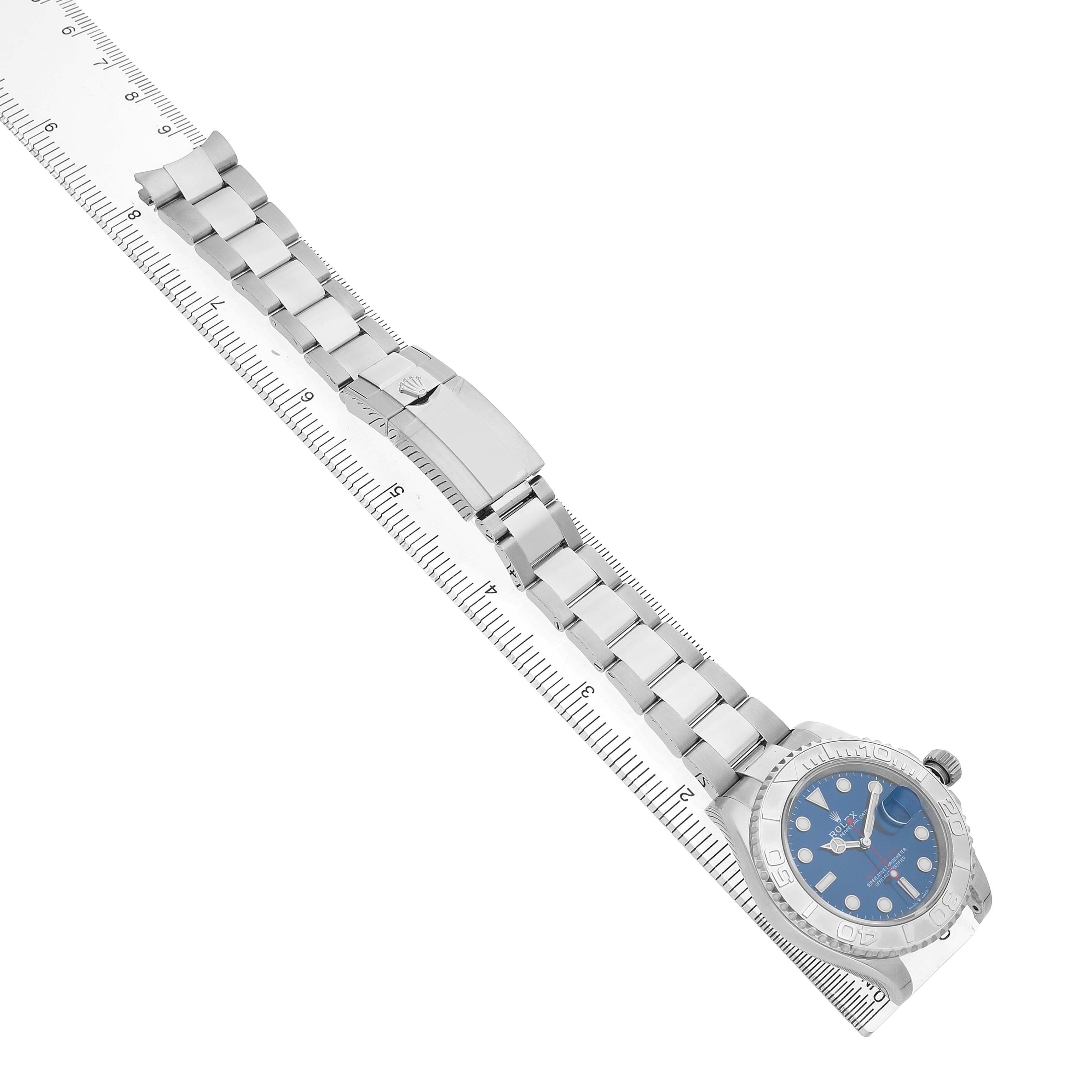 The Rolex Yacht-Master 126622 Men's Stainless Steel Blue Dial watch is shown at an angle displaying the bracelet, clasp, and face positioned alongside a ruler.