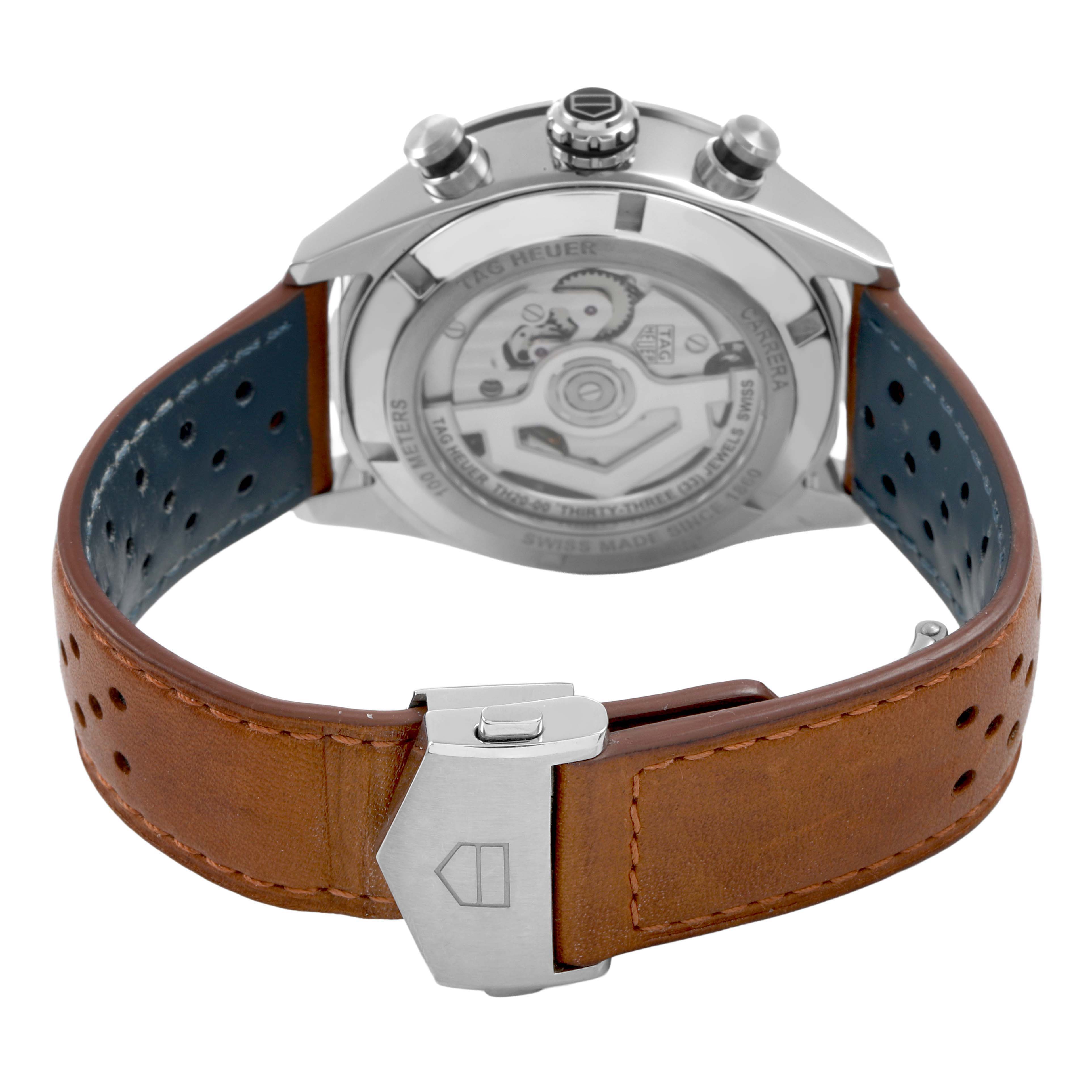 The image shows the back view of a Tag Heuer Carrera CBN2A1A Men's Stainless Steel Blue Dial watch, highlighting its transparent case back and clasp on a leather strap.