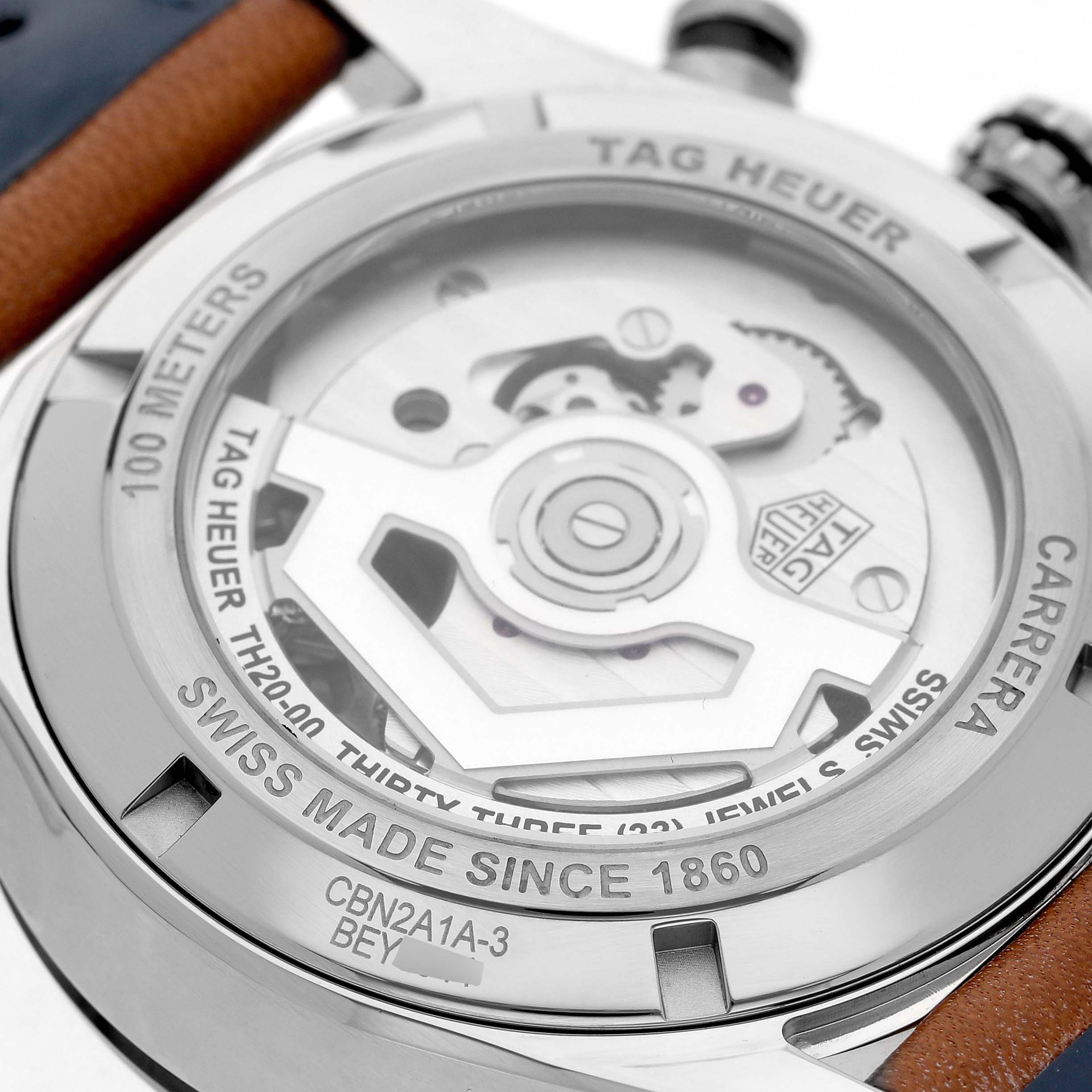 The image shows the back casing of a Tag Heuer Carrera CBN2A1A Men's Stainless Steel Blue Dial watch, highlighting the visible automatic movement and engravings.